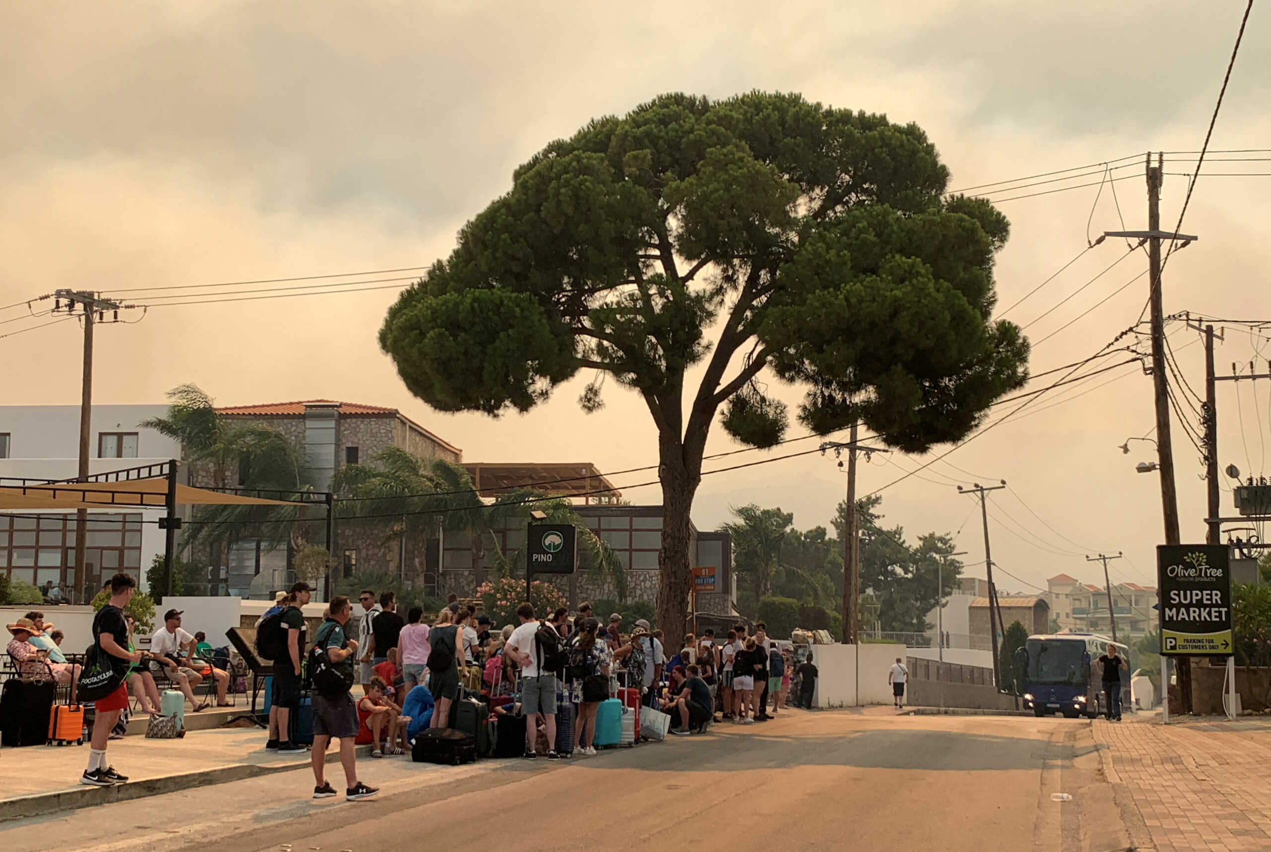 Tourists are being evacuated as wildfire burns near Lindos, on the island of Rhodes, Greece, July 22, 2023. REUTERS