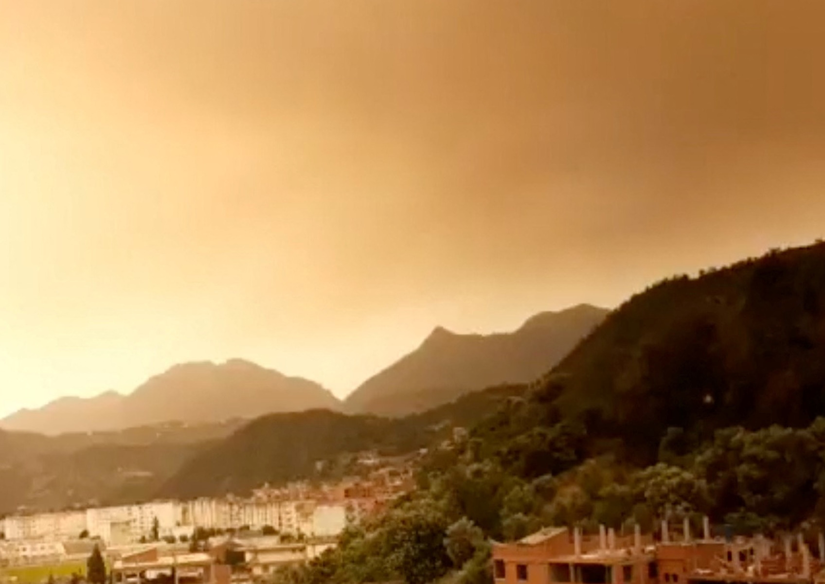 Smoke rises following a wildfire in Bejaia, Algeria, July 24, 2023 in this screengrab obtained from a social media video. Ammouri Abderahmane