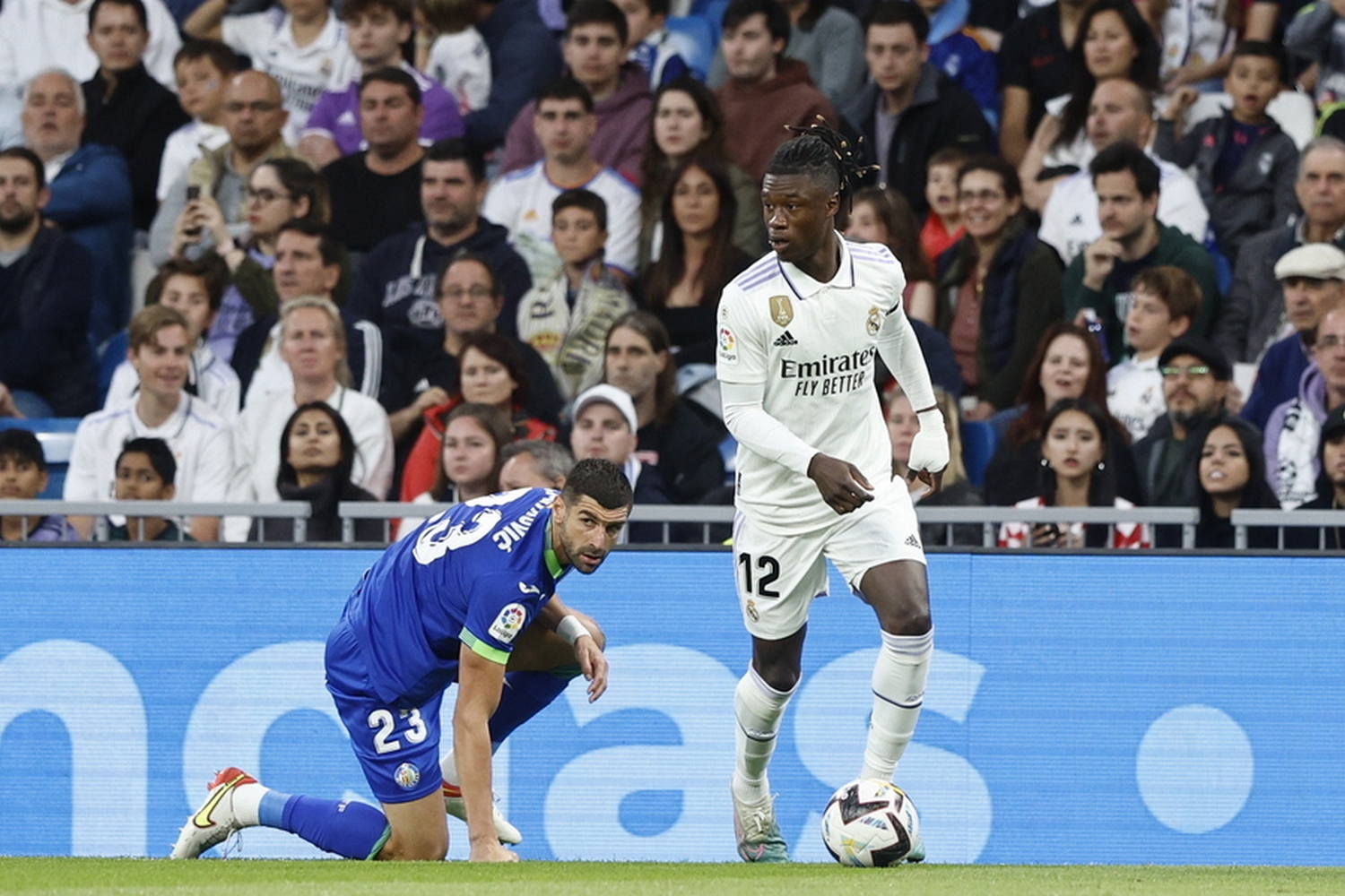 epa10625854 Real Madrid's midfielder Eduardo Camavinga (R) in action against Getafe's defender Stefan Mitrovic (L) during the Spanish LaLiga soccer match between Real Madrid and Getafe CF at Santiago Bernabeu Stadium in Madrid, Spain, 13 May 2023.  EPA
