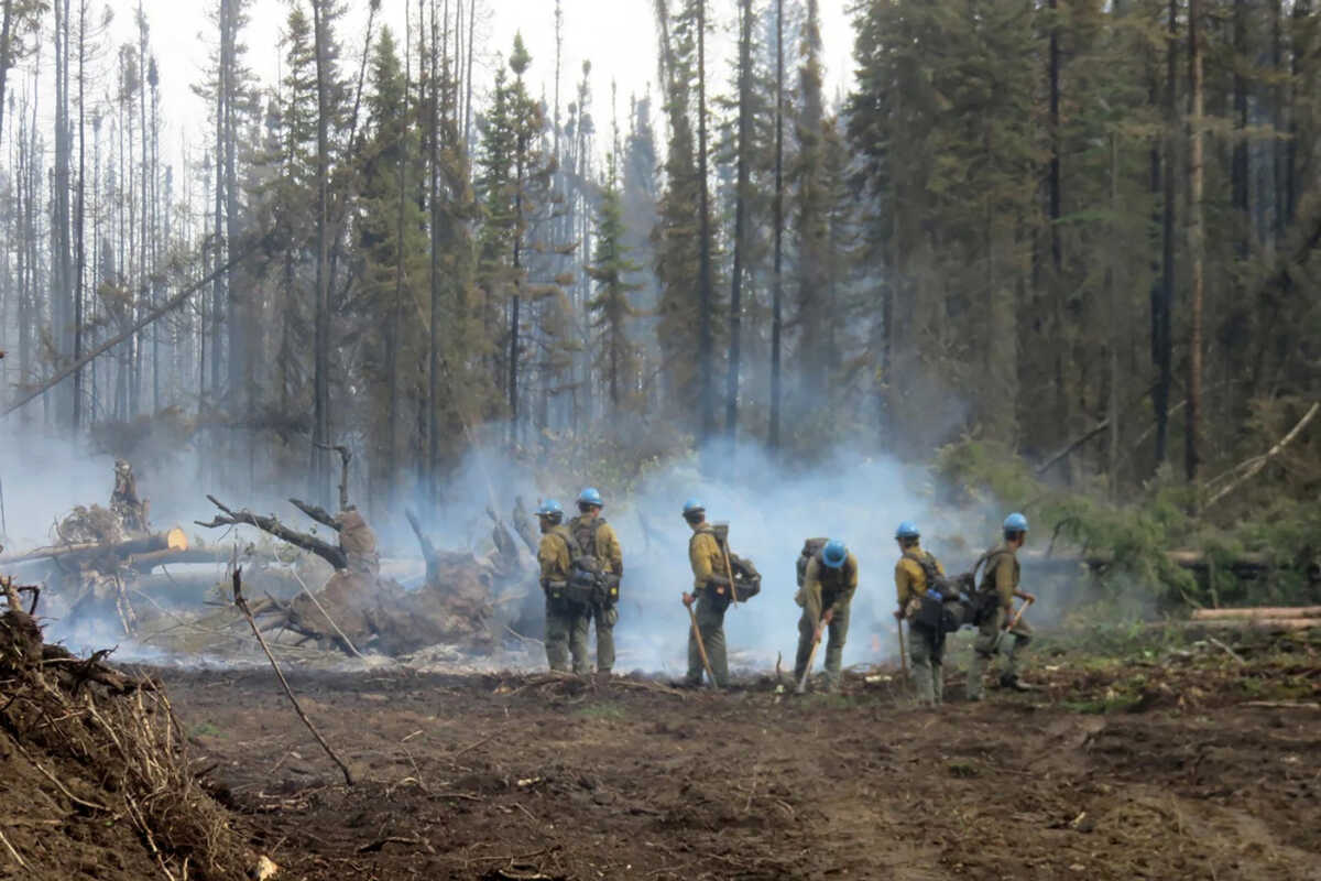 American firefighters work on the Basset Complex wildfire near Paddle Prairie Metis Settlement, Alberta, Canada July 10, 2023. Alberta Wildfire