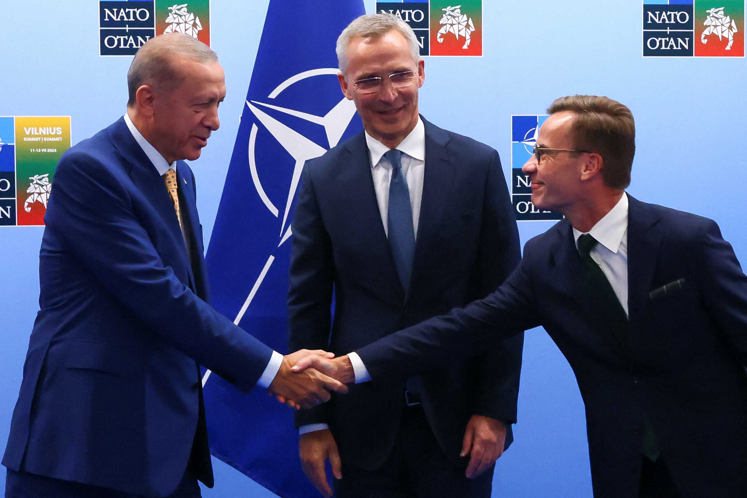 Turkish President Tayyip Erdogan and Swedish Prime Minister Ulf Kristersson shake hands next to NATO Secretary-General Jens Stoltenberg prior to their meeting, on the eve of a NATO summit, in Vilnius, Lithuania July 10, 2023. REUTERS