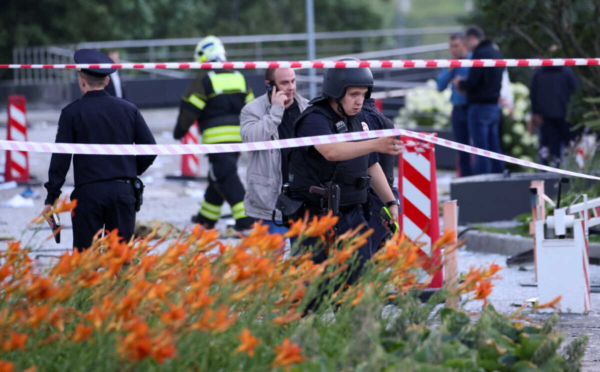 Russian law enforcement officers and emergencies ministry members work at an accident scene near the damaged office building in the Moscow City following a reported Ukrainian drone attack in Moscow, Russia, July 30, 2023. REUTERS