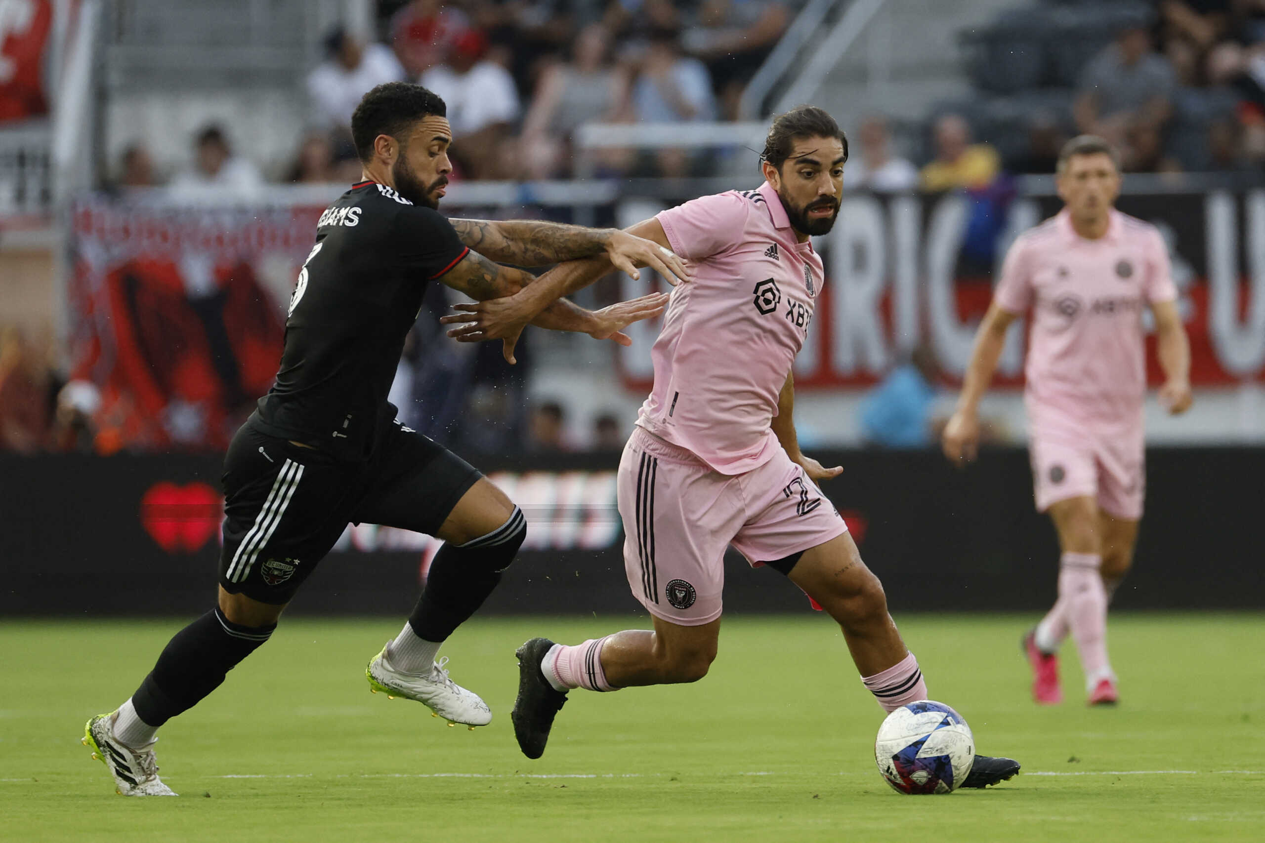 Jul 8, 2023; Washington, District of Columbia, USA; Inter Miami CF midfielder Rodolfo Pizarro (20) dribbles the ball as D.C. United defender Derrick Williams (3) chases in the first half at Audi Field. Mandatory Credit: Geoff Burke-USA TODAY Sports