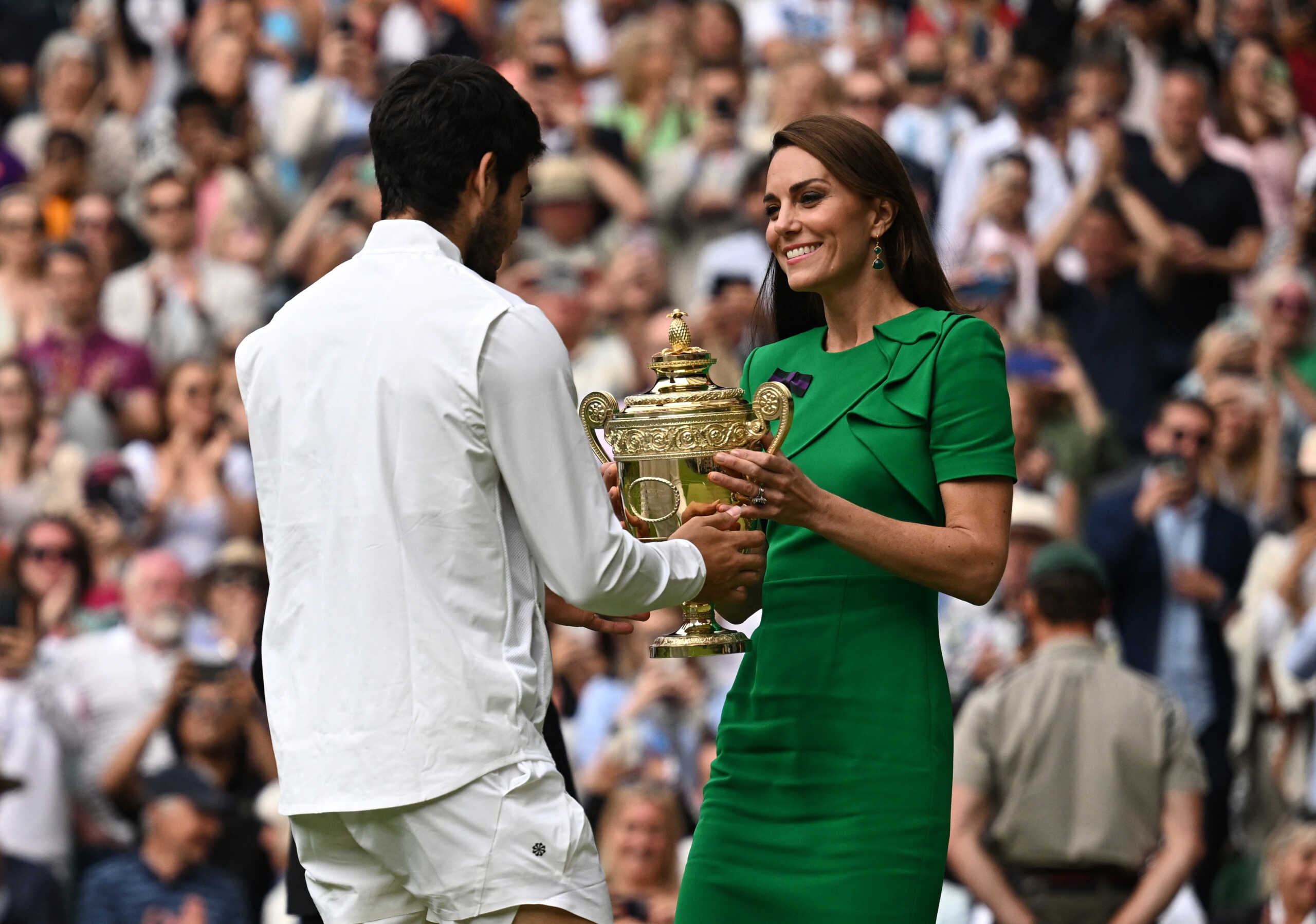Tennis - Wimbledon - All England Lawn Tennis and Croquet Club, London, Britain - July 16, 2023 Spain's Carlos Alcaraz receives the trophy from Britain's Catherine, Princess of Wales after winning his final match against Serbia's Novak Djokovic REUTERS