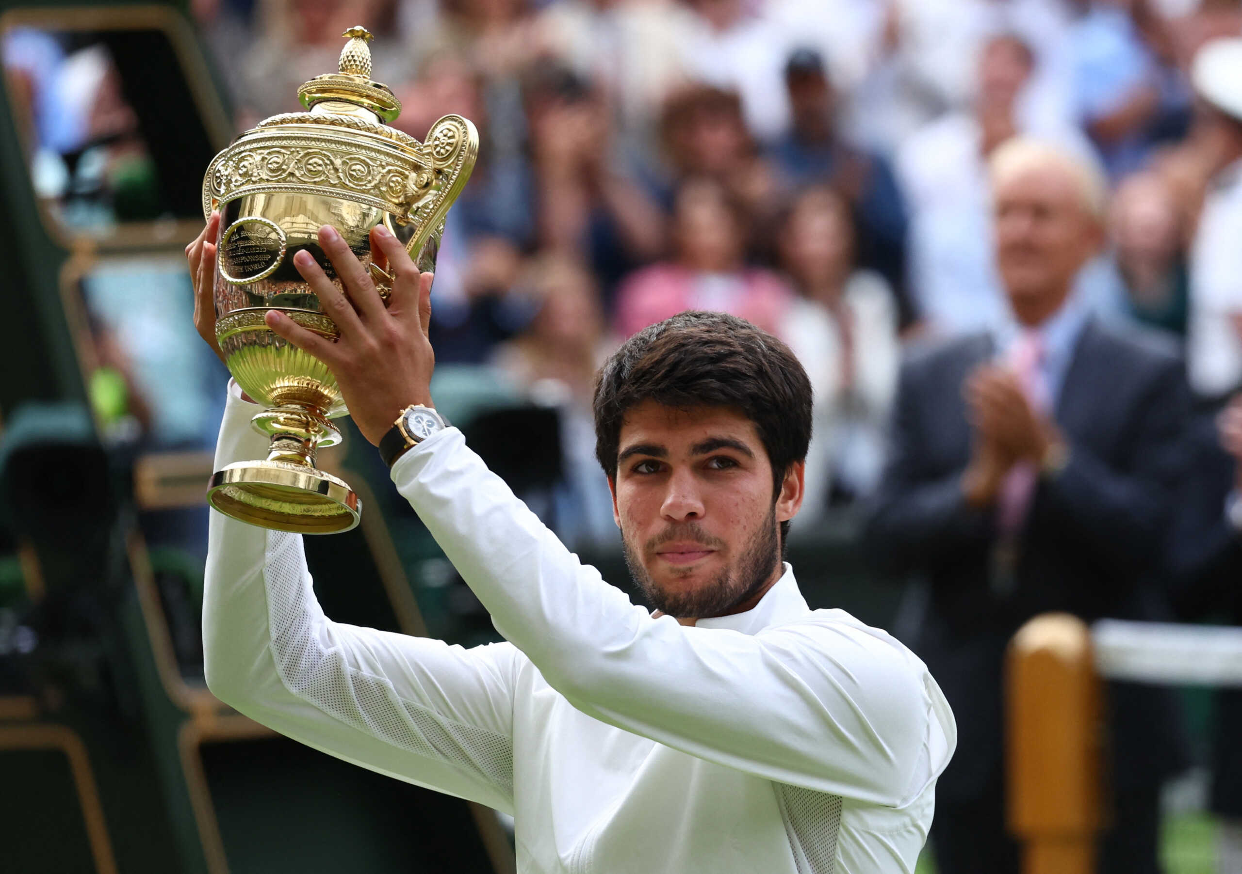 Tennis - Wimbledon - All England Lawn Tennis and Croquet Club, London, Britain - July 16, 2023 Spain's Carlos Alcaraz celebrates with the trophy after winning his final match against Serbia's Novak Djokovic REUTERS