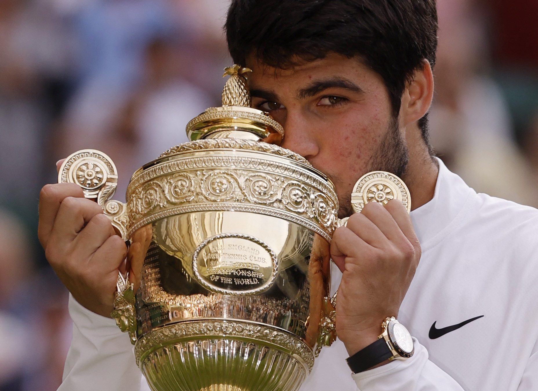 Tennis - Wimbledon - All England Lawn Tennis and Croquet Club, London, Britain - July 16, 2023 Spain's Carlos Alcaraz celebrates with the trophy after winning his final match against Serbia's Novak Djokovic REUTERS
