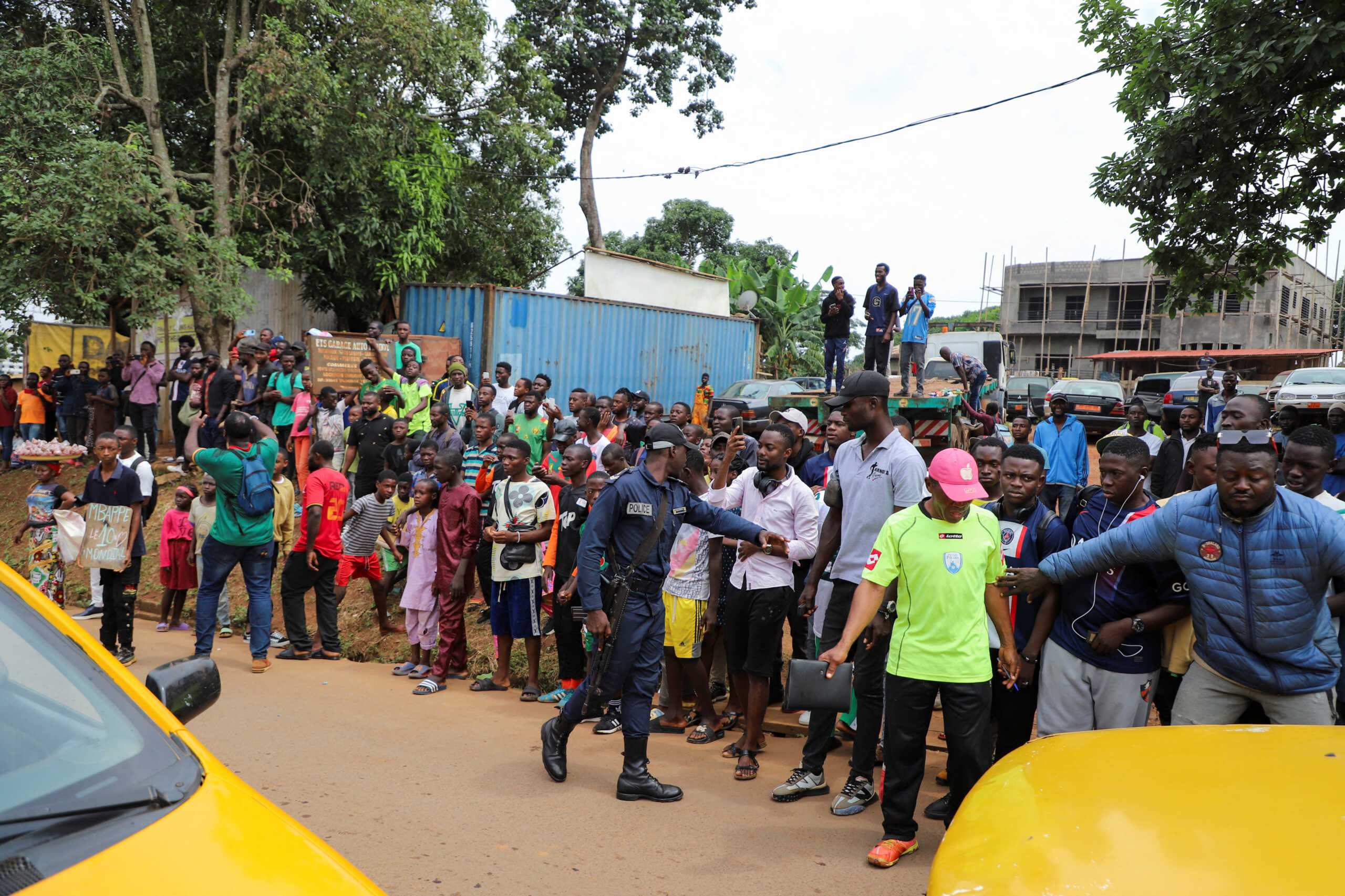 People gather as they wait for the French international soccer star Kylian Mbappe, who continues his first visit to his father's homeland in Yaounde, Cameroon July 7, 2023. REUTERS
