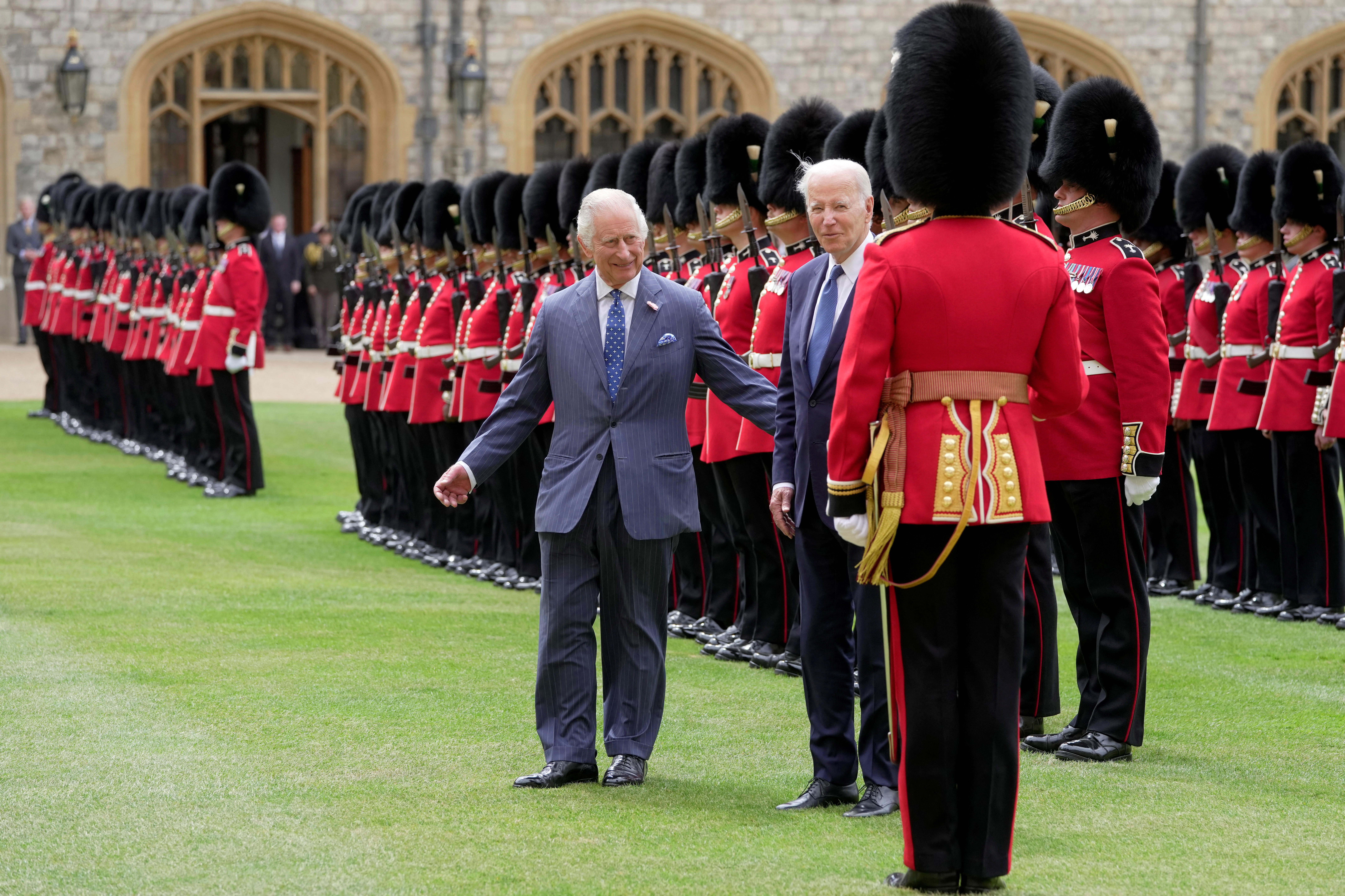 U.S. President Joe Biden and Britain's King Charles review an honour guard at Windsor Castle in Windsor, England, Monday, July 10, 2023.  Kin Cheung