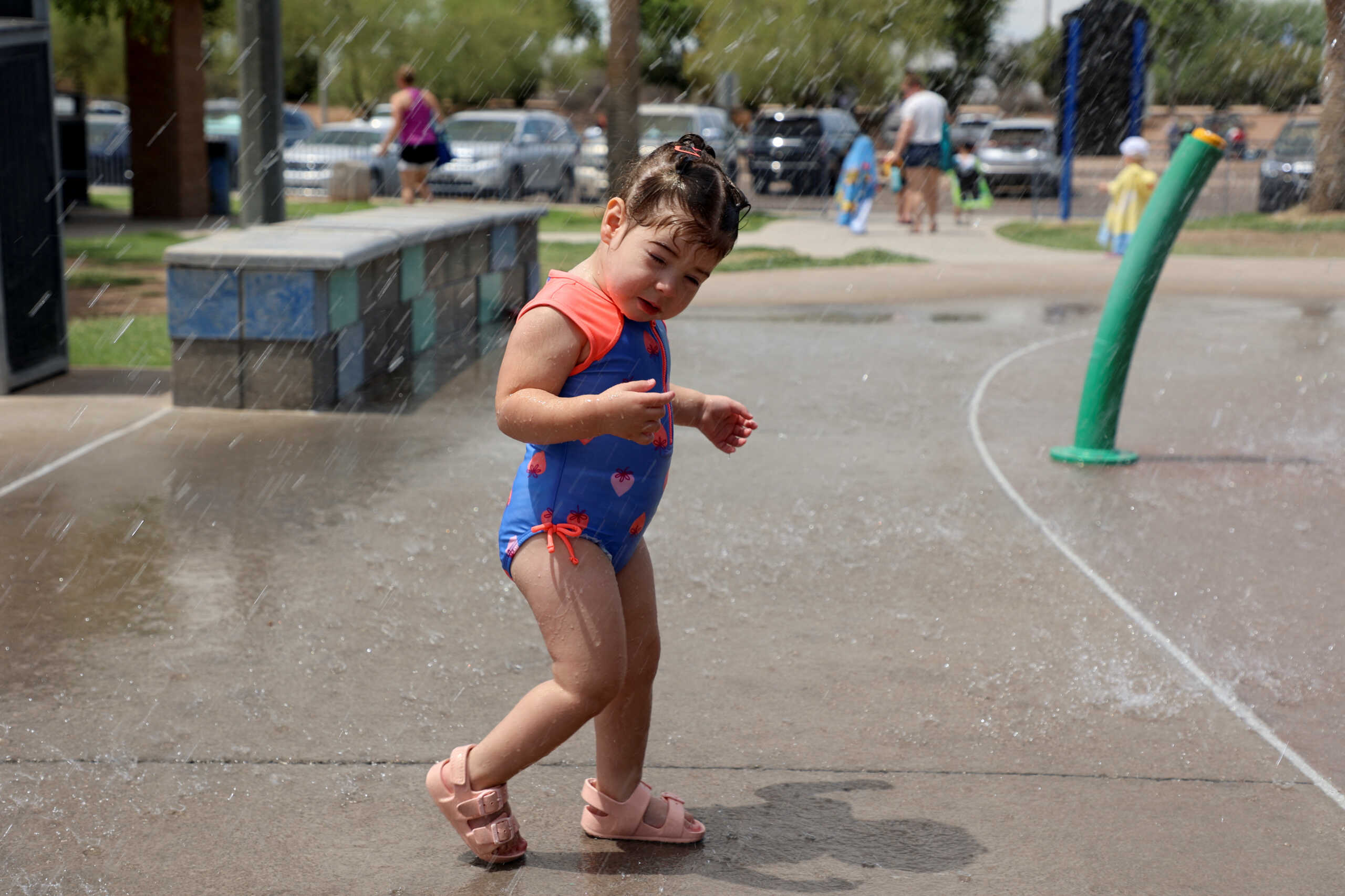 A child cools off at a water park during a heatwave in Phoenix, Arizona, U.S., July 16, 2023. REUTERS