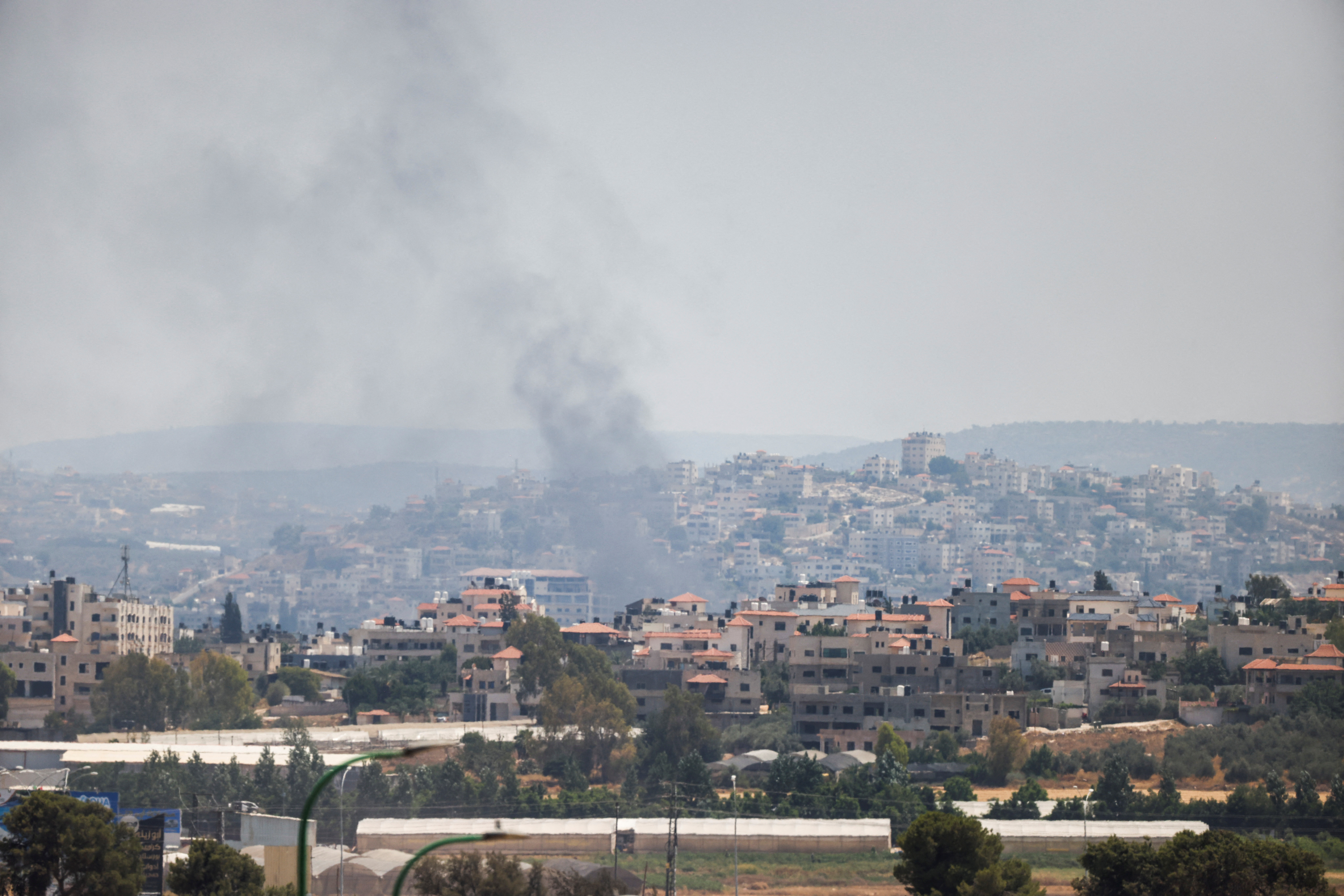 Smoke on the horizon is seen from Israel's side during a raid on Jenin refugee camp in the Israeli-occupied West Bank, Salem checkpoint July 3, 2023 REUTERS