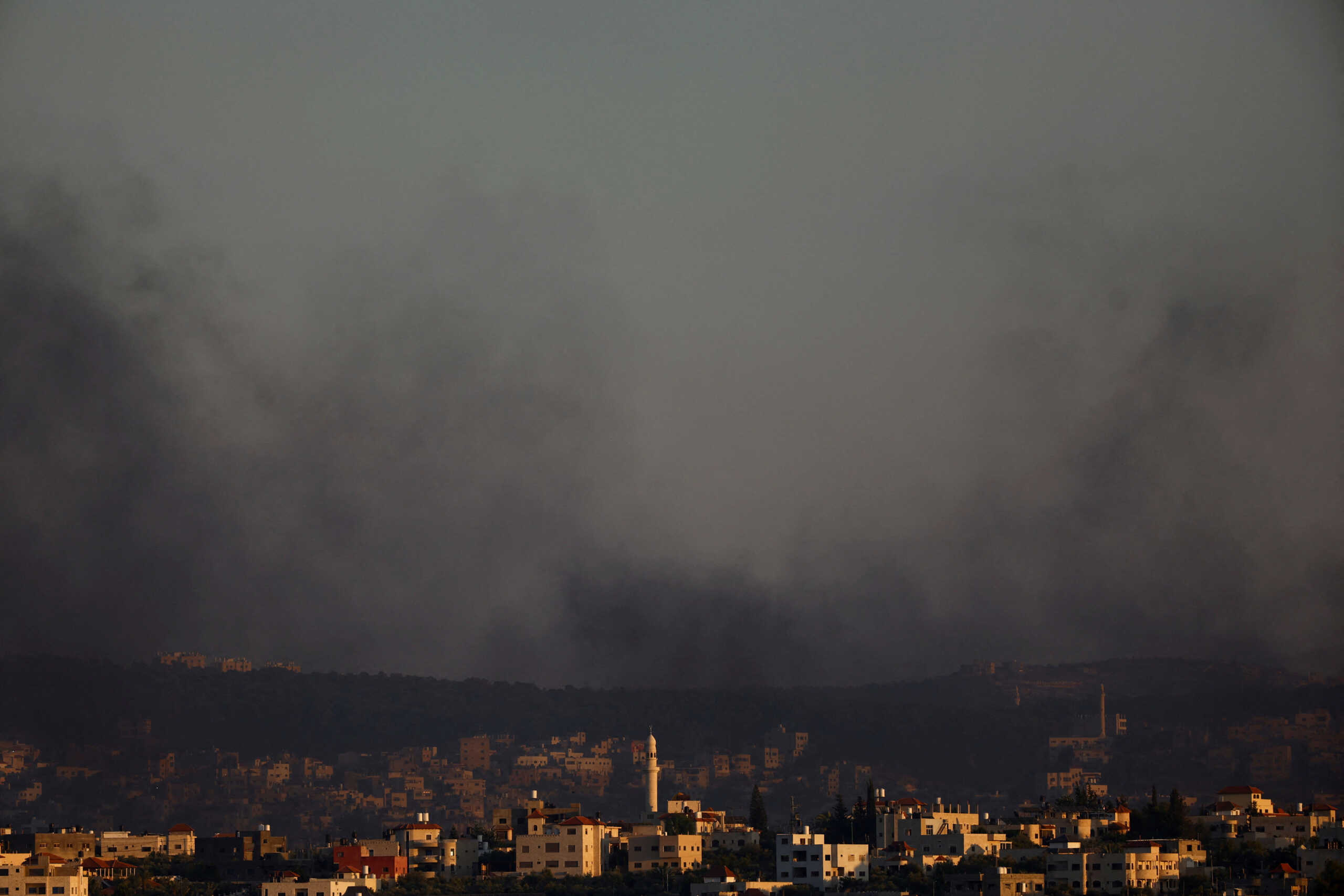 Smoke is seen from Israel's side during a raid on Jenin refugee camp in the Israeli-occupied West Bank, Jalamah checkpoint July 3, 2023 REUTERS