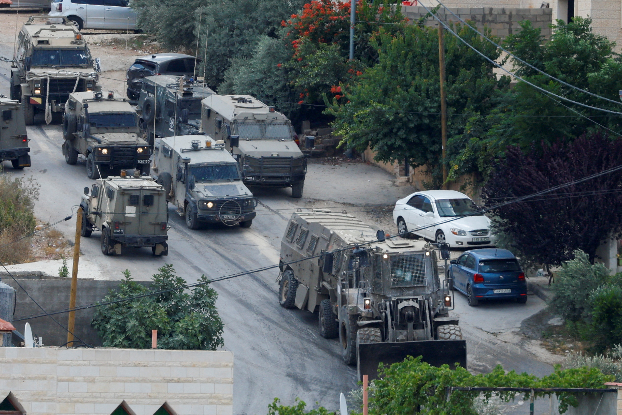 An Israeli military vehicle damaged during clashes with Palestinian gunmen is towed by a machinery during an Israeli raid in Jenin, in the Israeli-occupied West Bank June 19, 2023. REUTERS