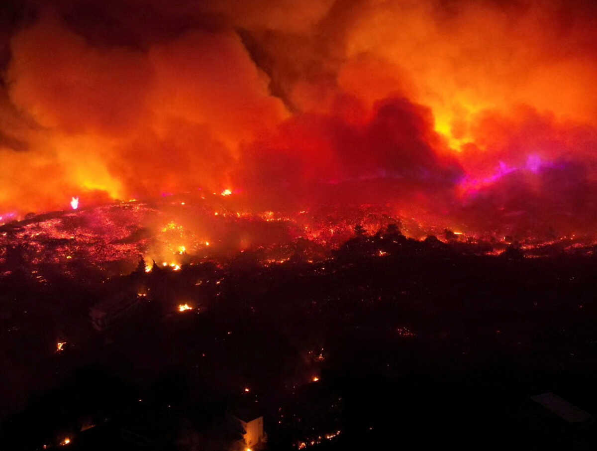 Smoke rises from a wildfire on the island of Rhodes, Greece, July 23, 2023, in this picture obtained from social media. Ted G. Bailos via REUTERS  THIS IMAGE HAS BEEN SUPPLIED BY A THIRD PARTY. MANDATORY CREDIT.     TPX IMAGES OF THE DAY