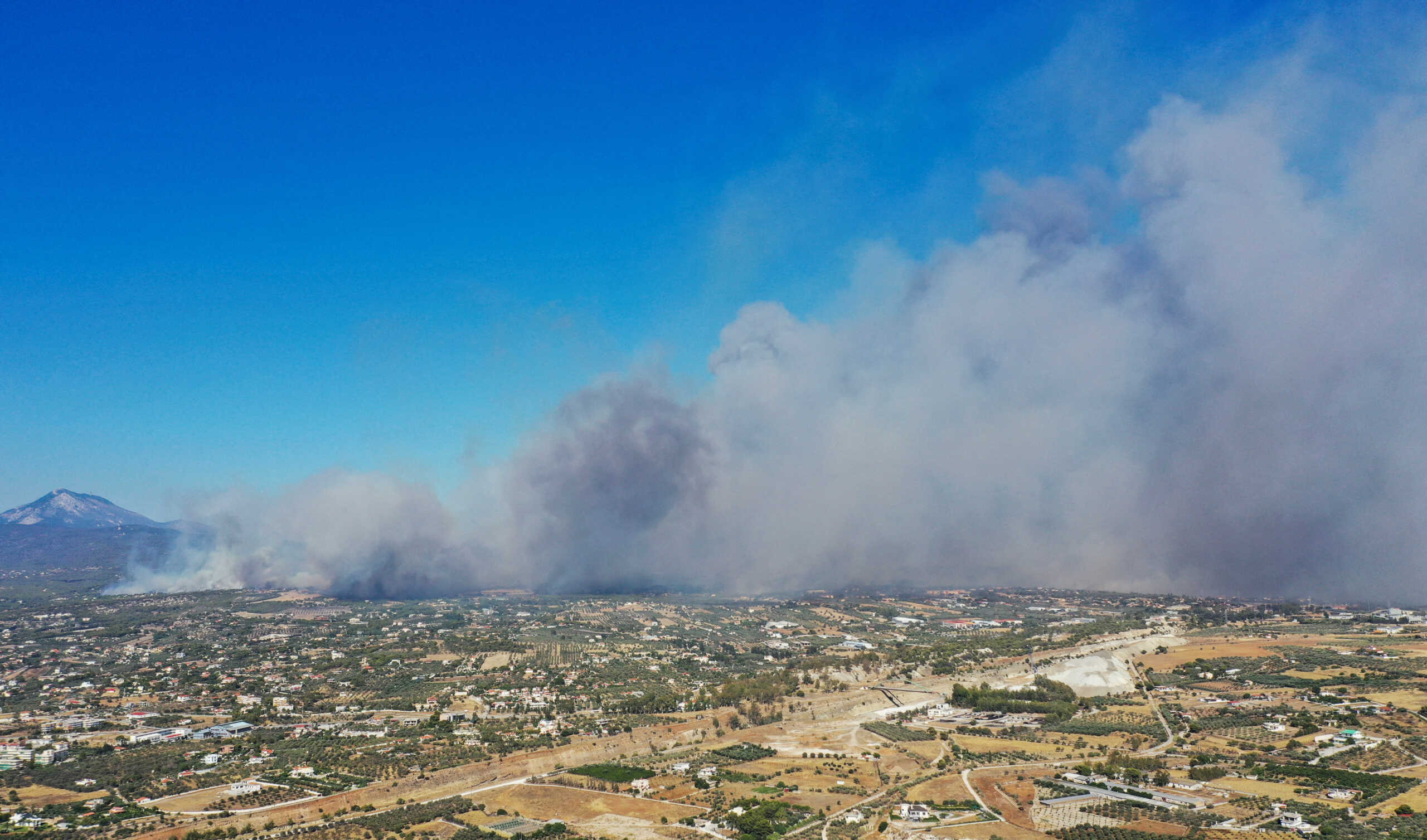 Smoke rises as a wildfire burns in Loutraki, Greece, July 17, 2023. REUTERS