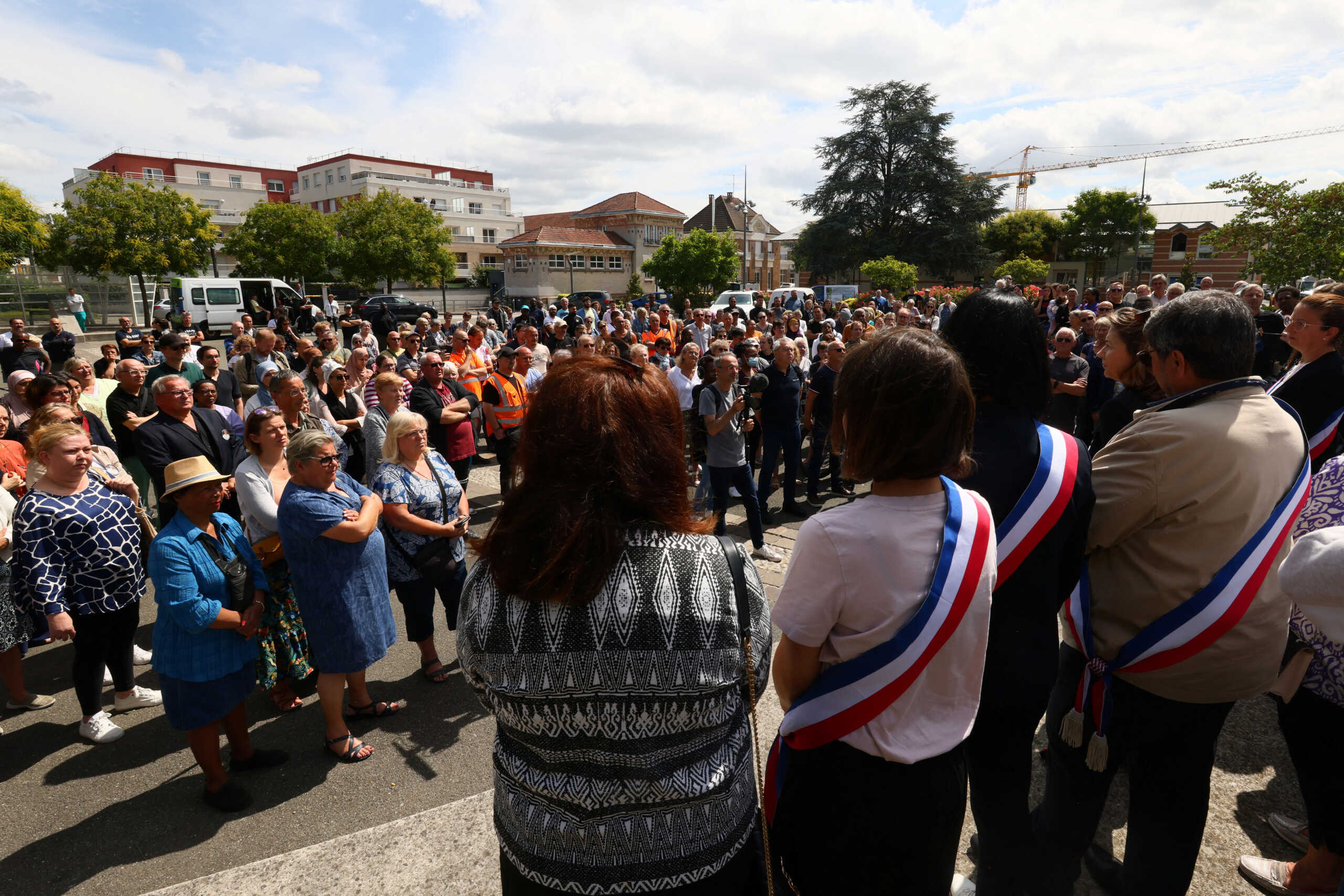 French elected officials and residents attend a "citizens gathering" in front of the town hall of Persan, which was partially burnt during night clashes, following the death of Nahel, a 17-year-old teenager killed by a French police officer in Nanterre during a traffic stop, in Persan, near Paris, France, July 3, 2023. REUTERS