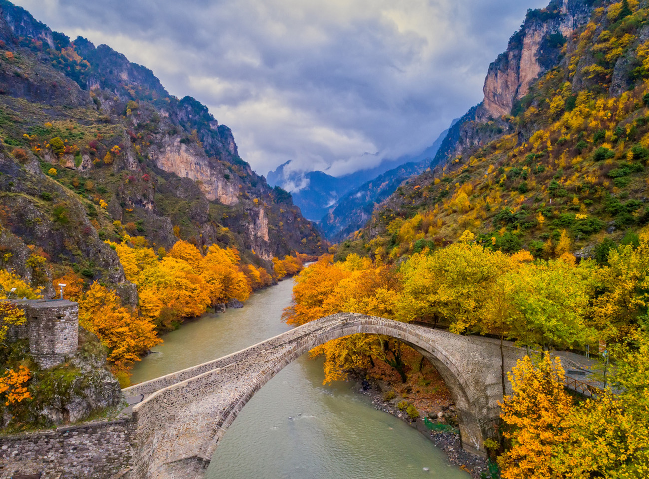 Aerial view of Konitsa old bridge and Aoos River an autumn day, Greece.