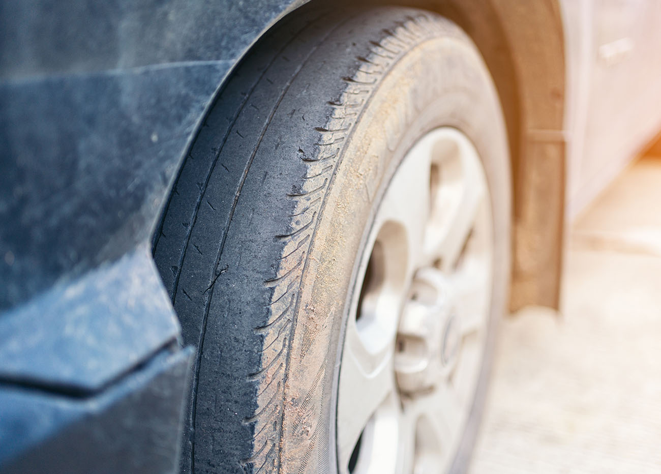 Care use unsafe tire, change time for a front wheel rubber worn, bald, black, old and low tread car tires. Driving on worn tires is a safety hazard