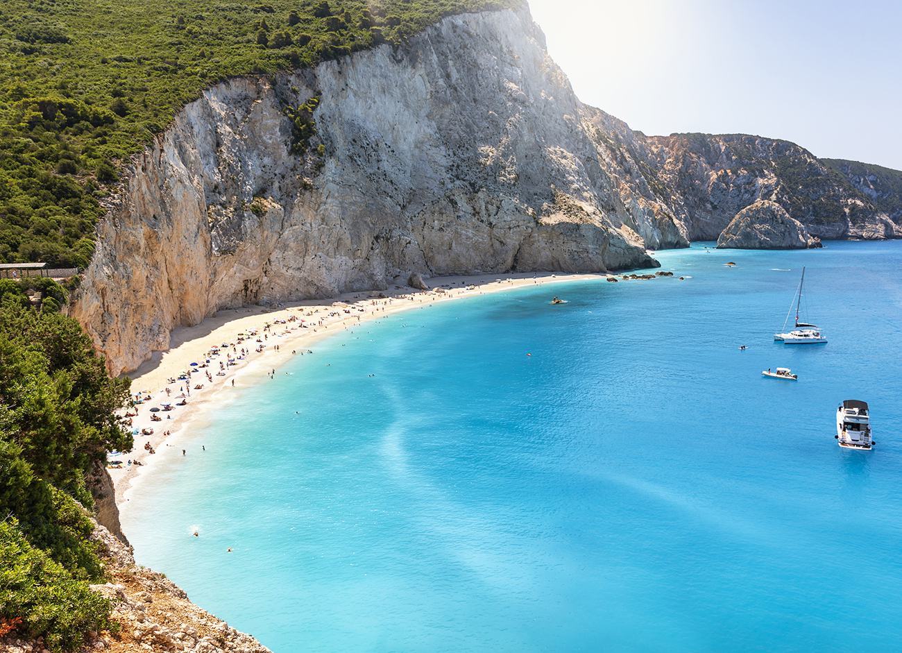 The beach of Port Katsiki during summer time with turquoise shining ocean on the island of Lefkada, Ionian Sea, Greece