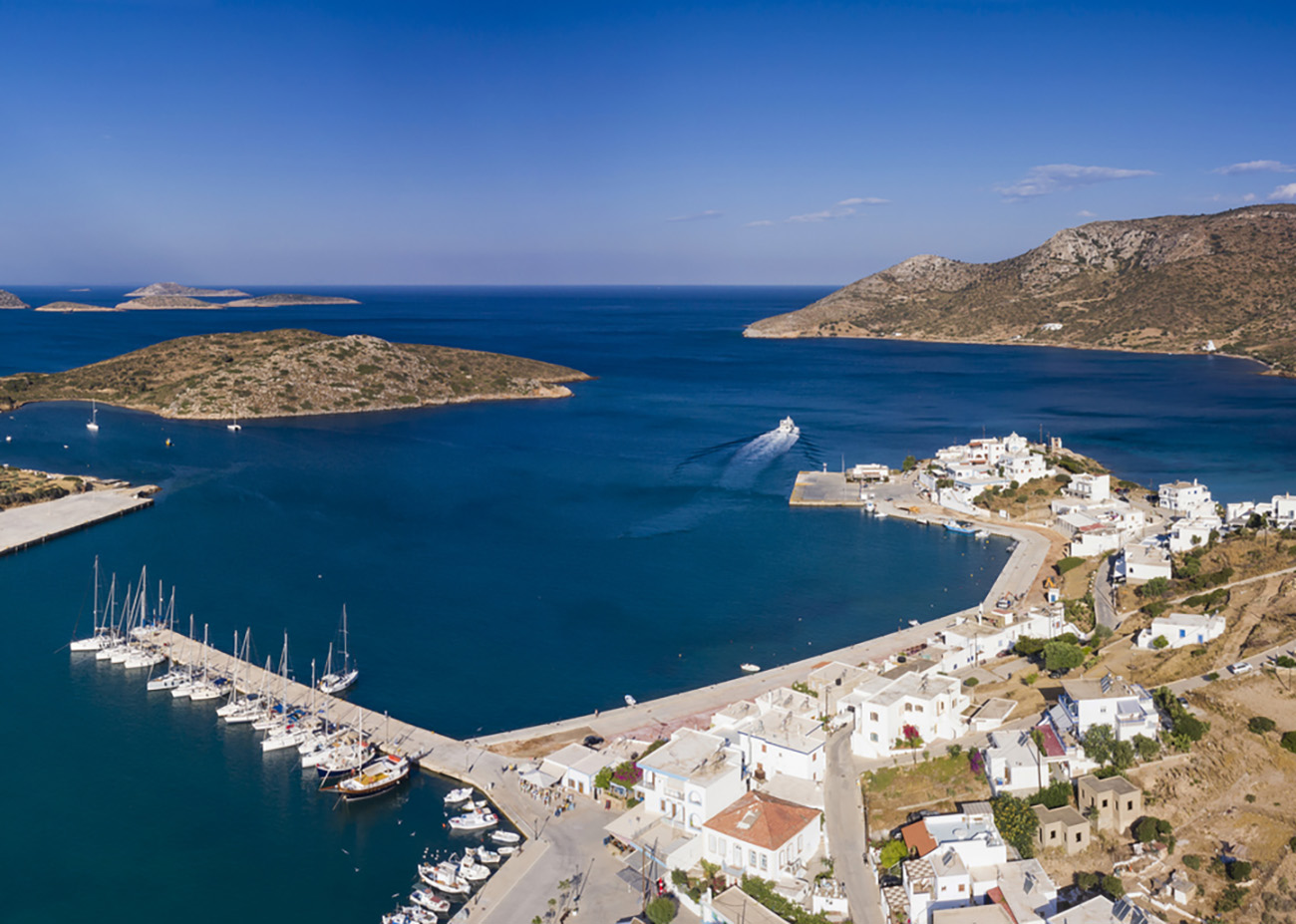 Aerial drone panoramic view of the Lipsi marina harbor with anchored sailboats located in the Dodecanese Cyclades islands of Greece in Europe