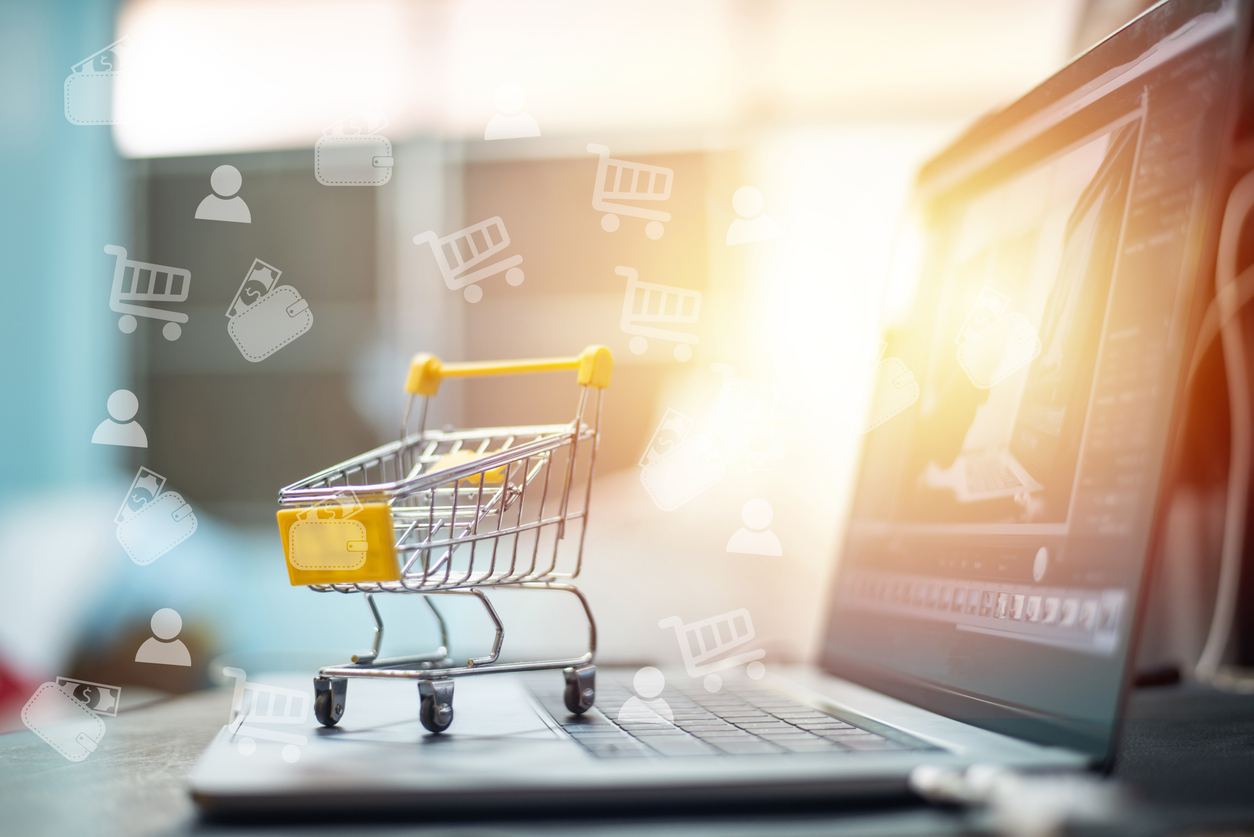 Yellow cart on laptop in shopping on line concept.