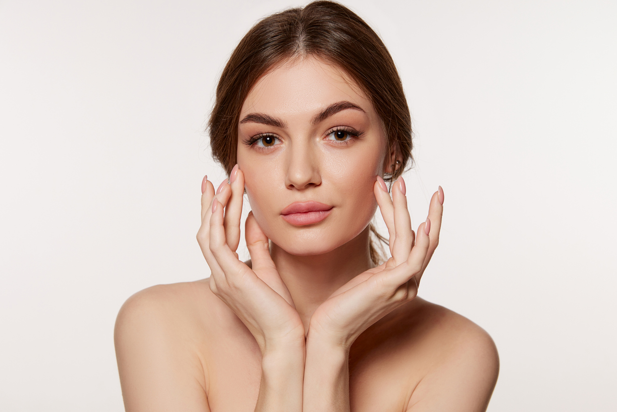 Portrait of young beautiful woman with perfect smooth skin isolated on white background. Taking care after skin condition. Concept of natural beauty, plastic surgery, cosmetology, cosmetics, skin care