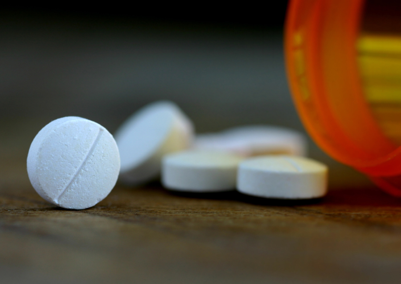 Pills spilling out of a pill bottle.