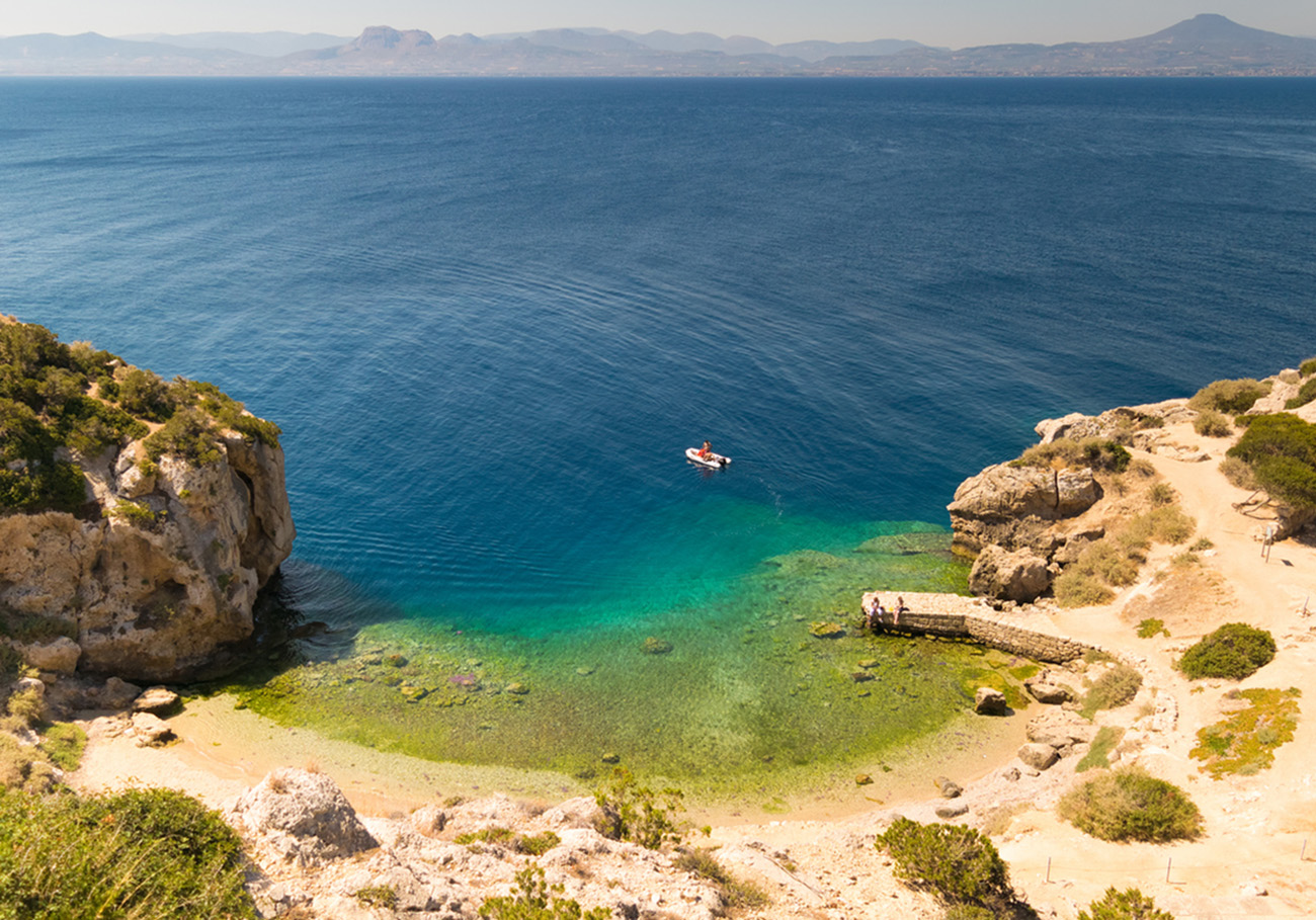 Perachora Ireon lake in Greece with beautiful green water and a fast boat in it.