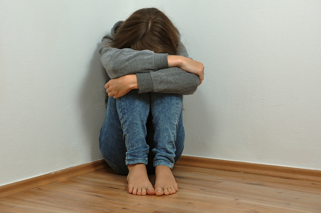 Lonely girl crying in the corner