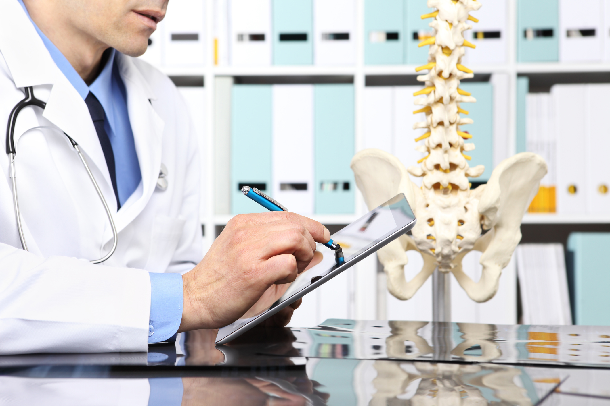 Radiologist doctor with digital tablet checking xray, healthcare, medical and radiology concept
