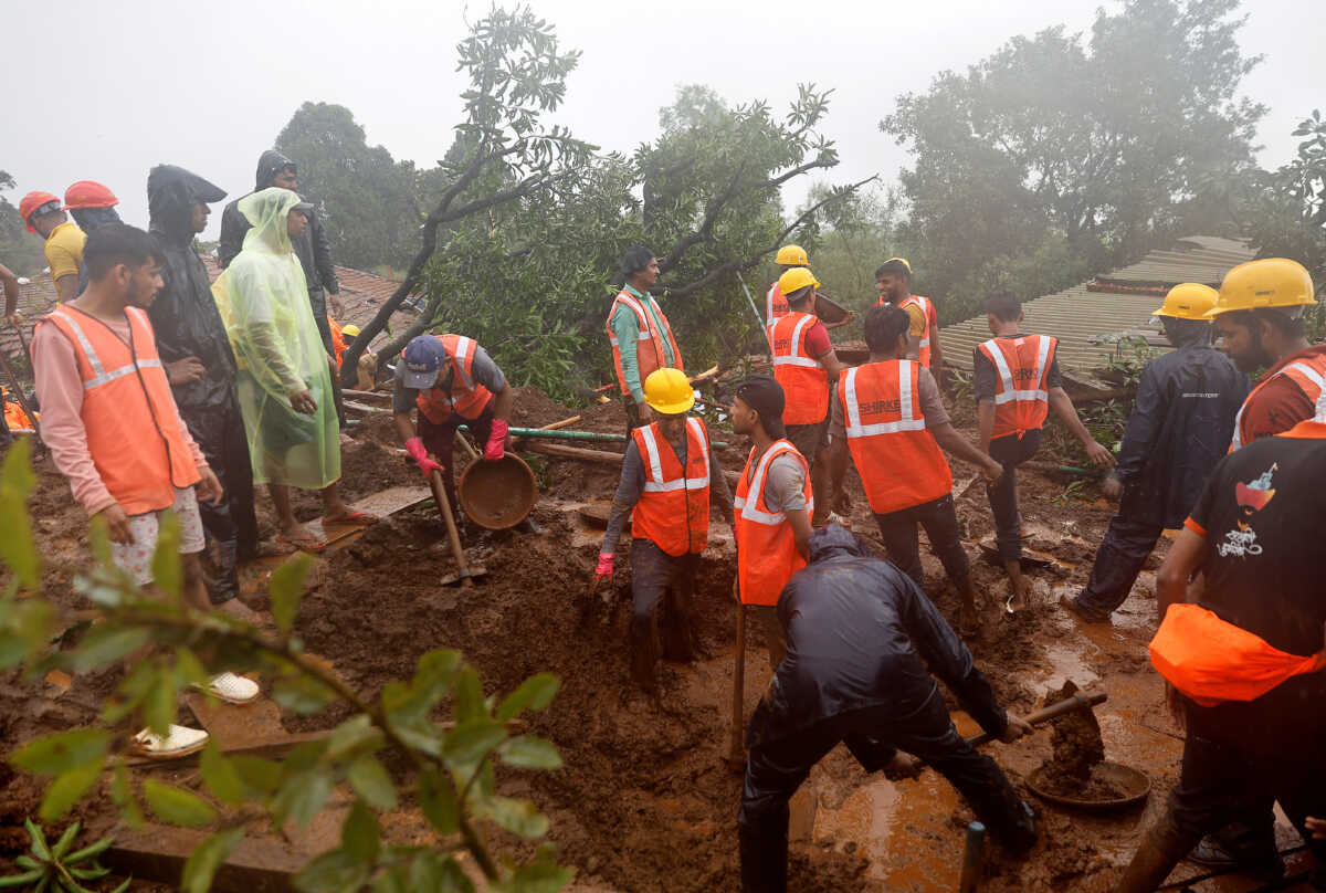 Members of rescue teams clear the debris as they search for survivors after a landslide following heavy rains in Raigad district in the western state of Maharashtra, India, July 20, 2023. REUTERS