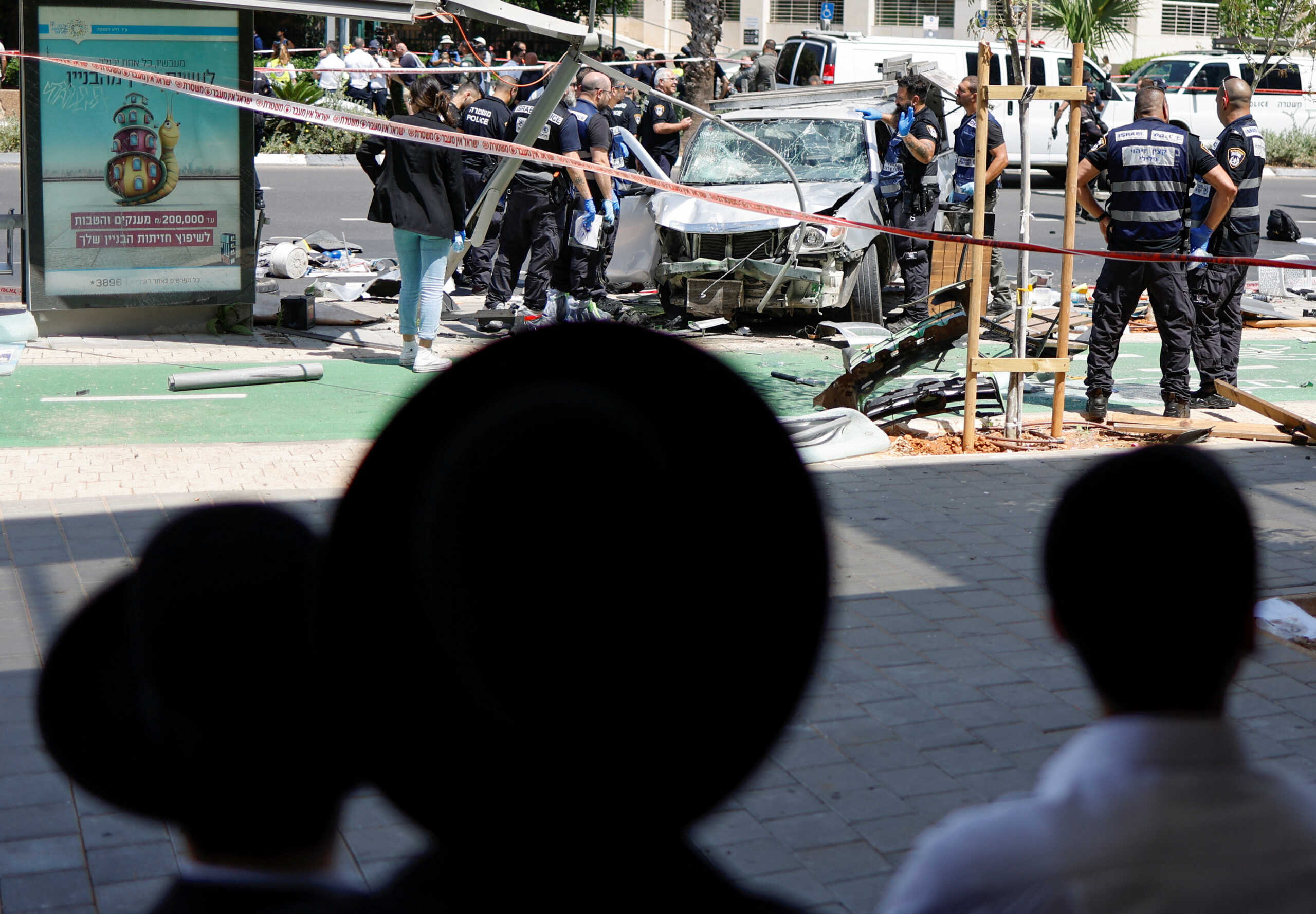 People watch as Israeli police work at the scene of a ramming attack in Tel Aviv, Israel July 4, 2023. REUTERS