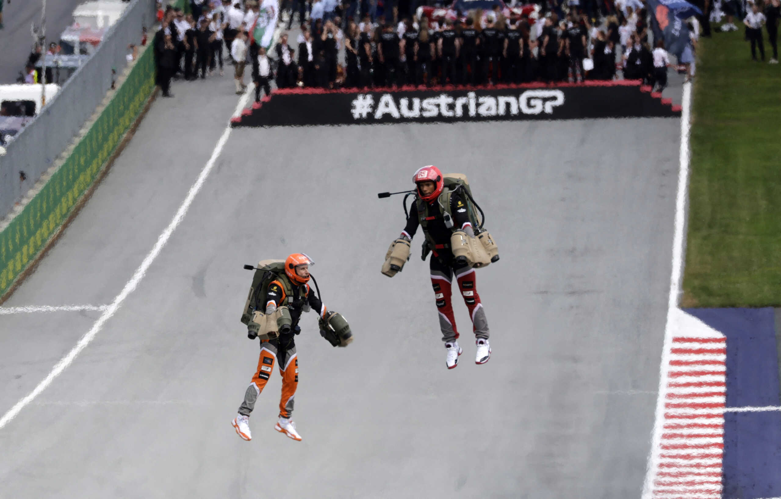 Formula One F1 - Austrian Grand Prix - Red Bull Ring, Spielberg, Austria - July 2, 2023 People are pictured flying with jetpacks above the track before the race REUTERS
