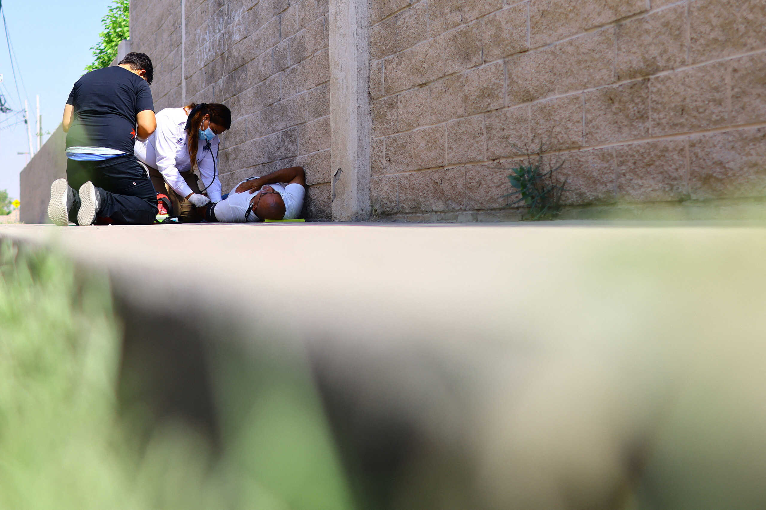 Paramedics attend to a person during a day of high temperatures, in Ciudad Juarez, Mexico June 27, 2023. REUTERS