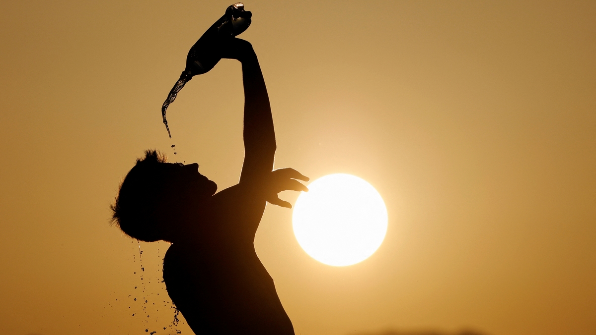 A runner cools down with water in Skopje, North Macedonia July 12, 2023. REUTERS