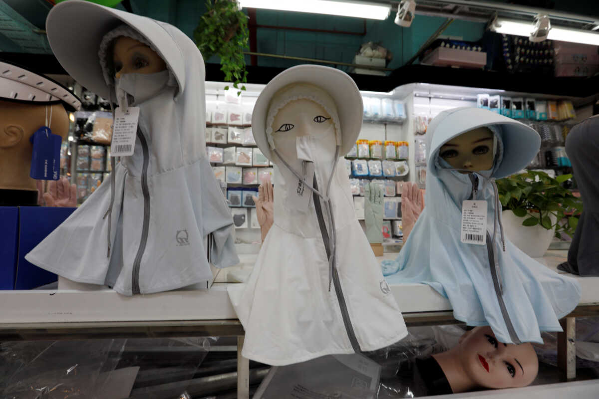 Mannequins with sun protection headgear are seen displayed at a store in a shopping mall, amid a yellow alert for heatwave in Beijing, China July 19, 2023. REUTERS
