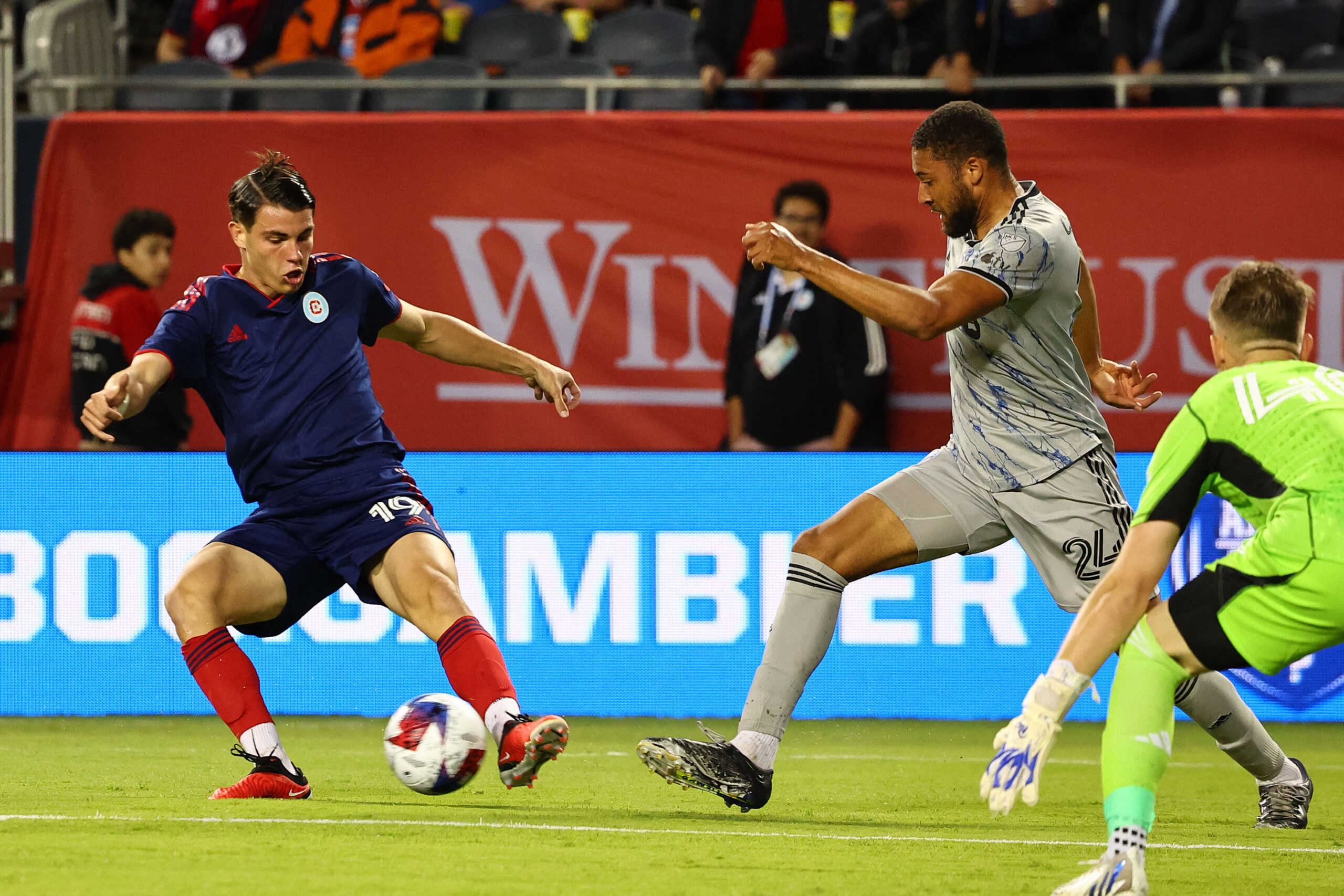 Jul 12, 2023; Chicago, Illinois, USA; Chicago Fire forward Georgios Koutsias (19) shoots the ball against CF Montreal defender George Campbell (24) during the first half at Soldier Field. Mandatory Credit: Mike Dinovo-USA TODAY Sports