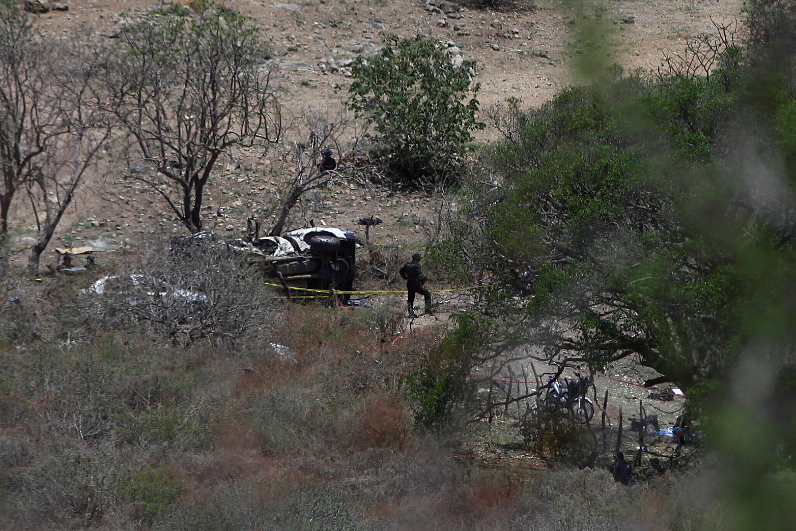 Security authorities work at the scene where suspected gang members killed police officers and members of the Jalisco state attorney general's office during an attack with explosives on Tuesday night, in Tlajomulco de Zuniga, Mexico July 12, 2023. REUTERS