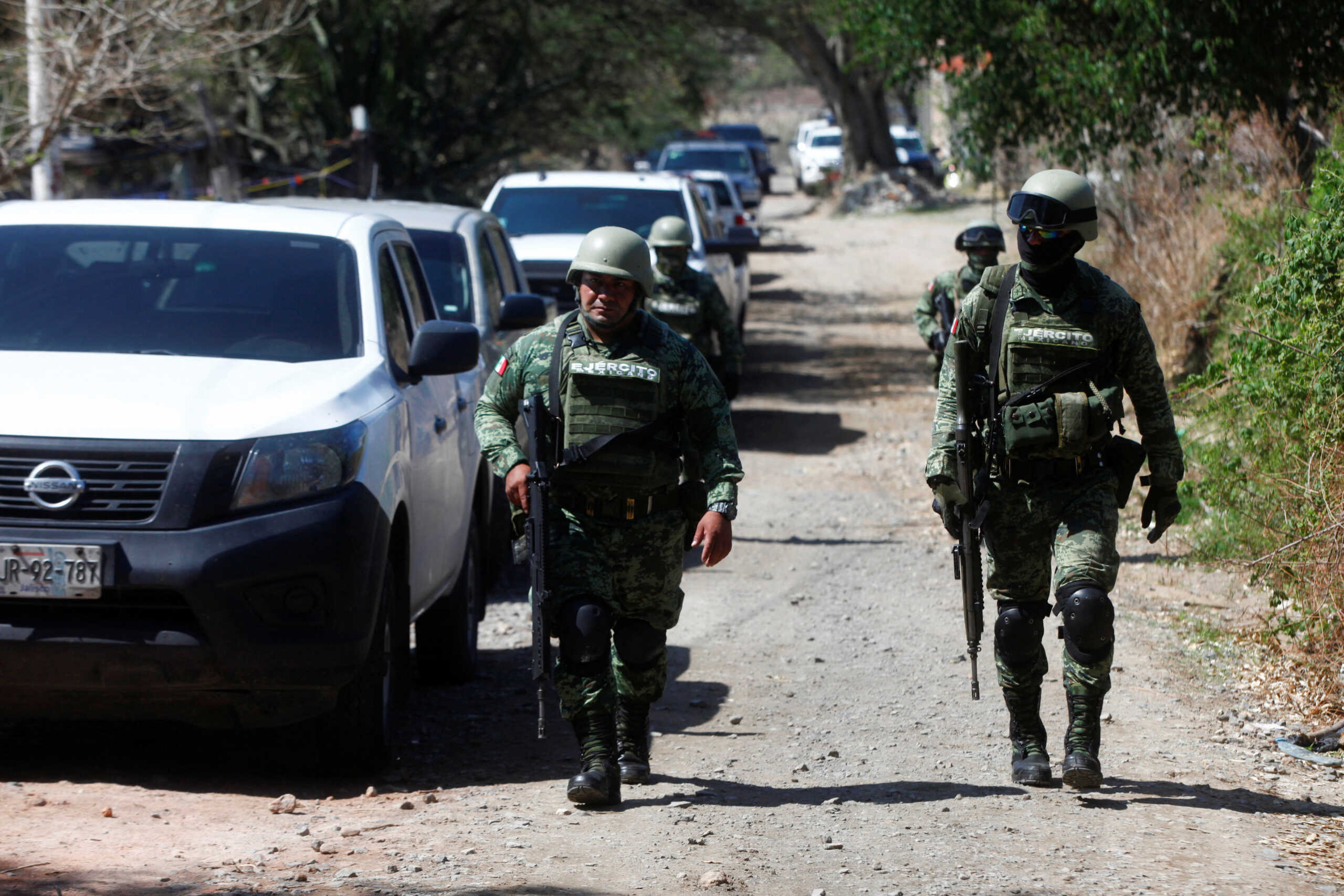 Soldiers walk near a scene where suspected gang members killed police officers and members of the Jalisco state attorney general's office during an attack with explosives on Tuesday night, in Tlajomulco de Zuniga, Mexico July 12, 2023. REUTERS