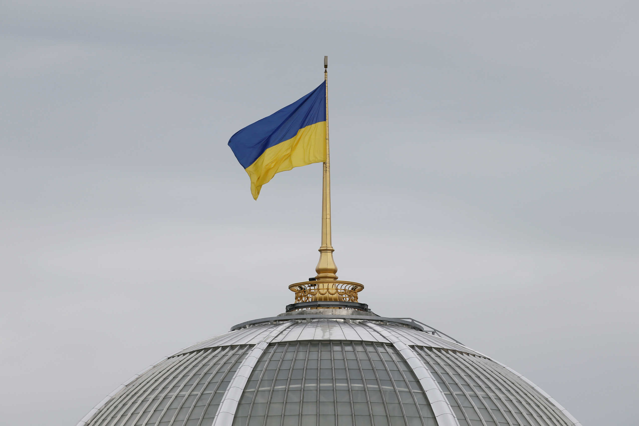 FILE PHOTO: A Ukrainian state flag, which is installed on the roof of the parliament building, flies in Kiev, Ukraine September 25, 2019. REUTERS