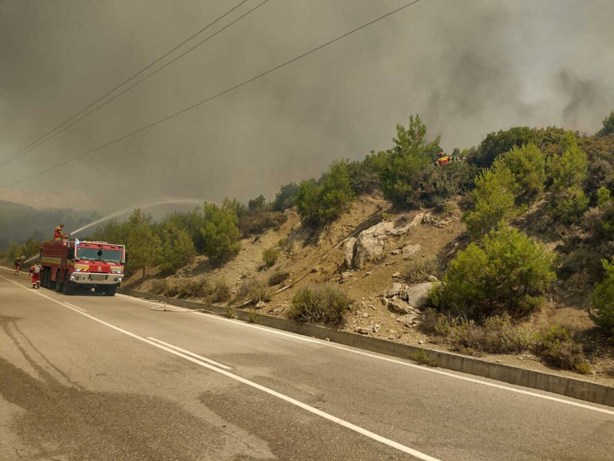 Firefighters try to extinguish a wildfire burning near Laerma, Rhodes Island, Greece, July 22, 2023. HAZZ Slovak Fire and Rescue Services