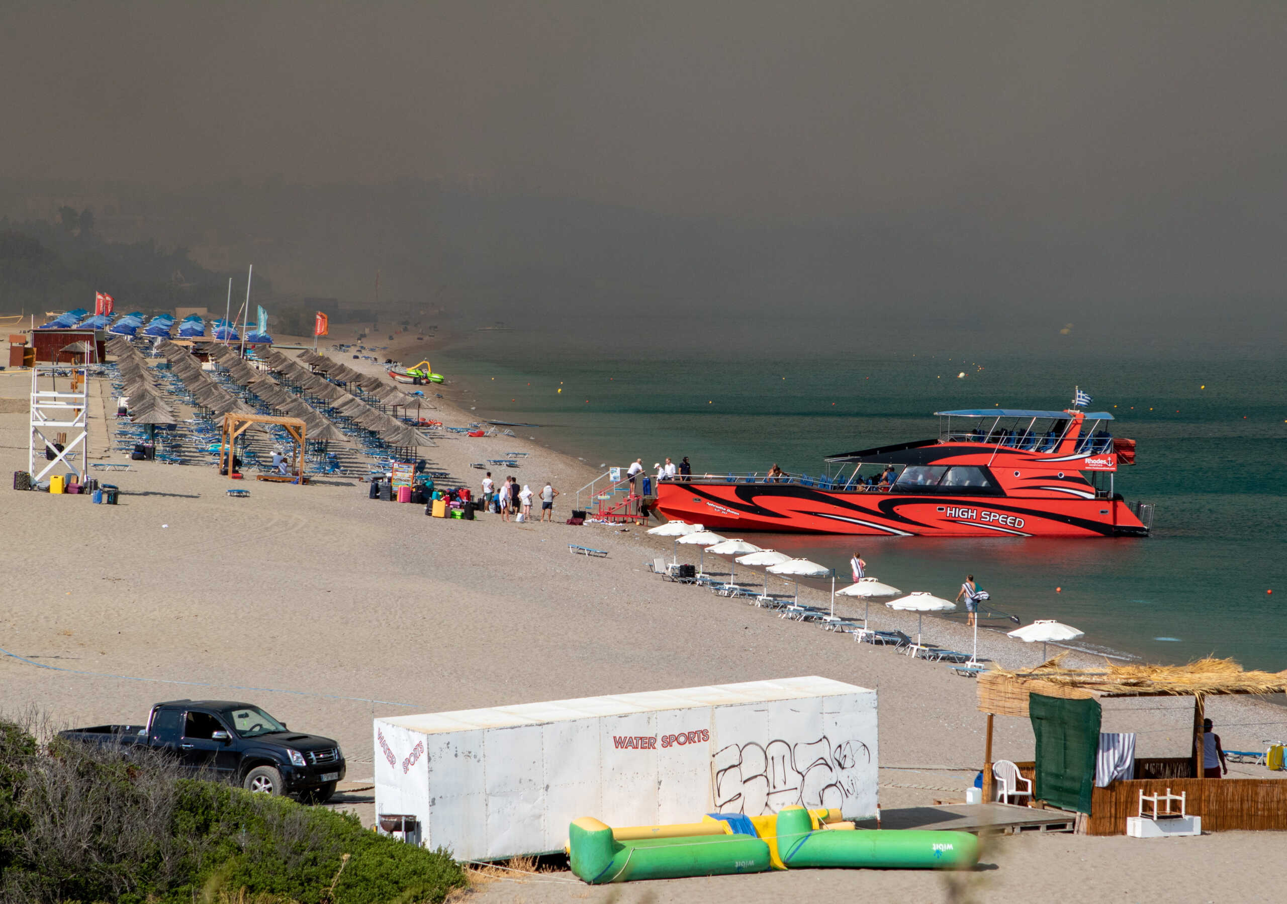 Tourists are being evacuated as wildfire burns near Lindos, on the island of Rhodes, Greece, July 22, 2023. REUTERS