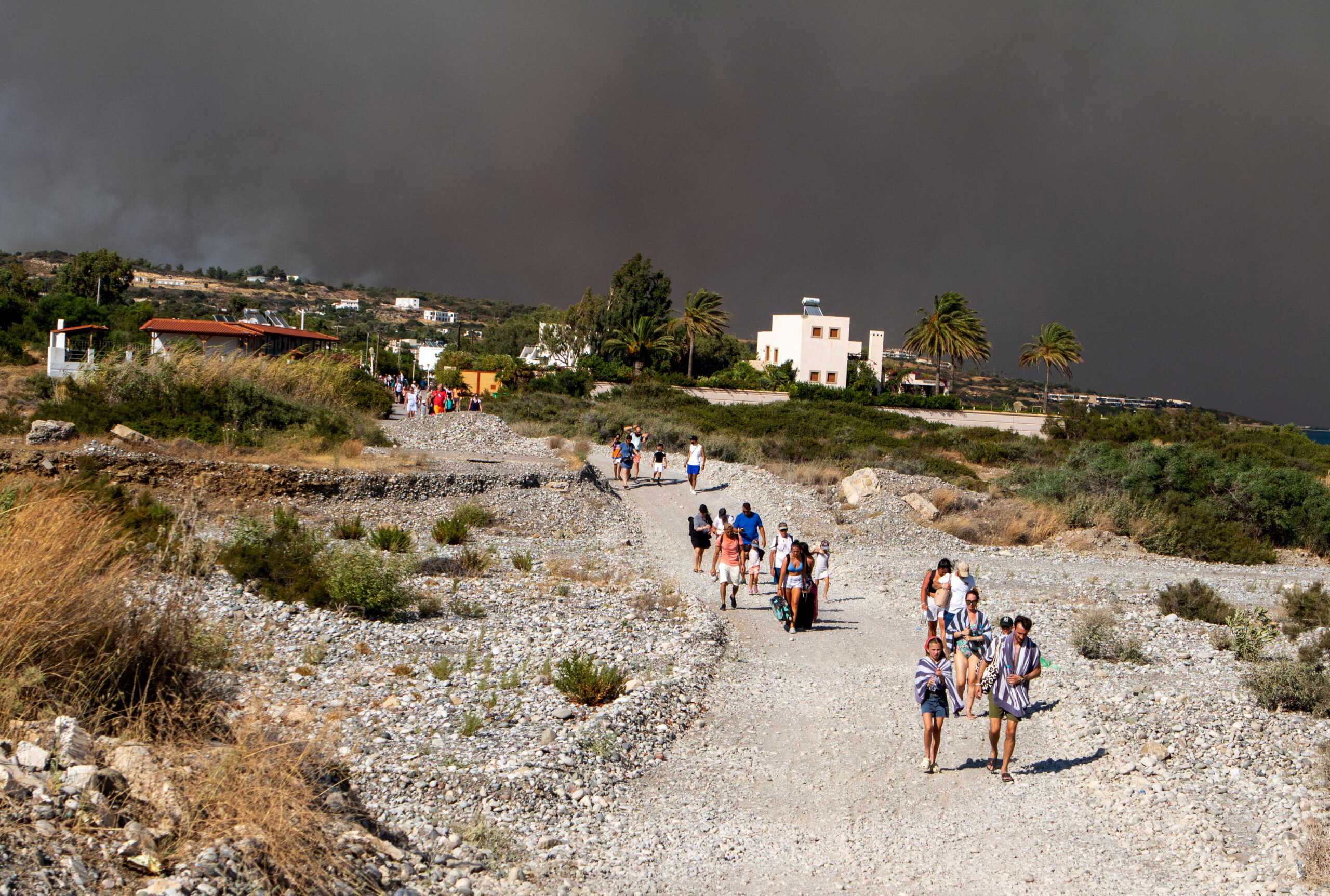 Tourists are being evacuated as wildfire burns near Lindos, on the island of Rhodes, Greece, July 22, 2023. REUTERS