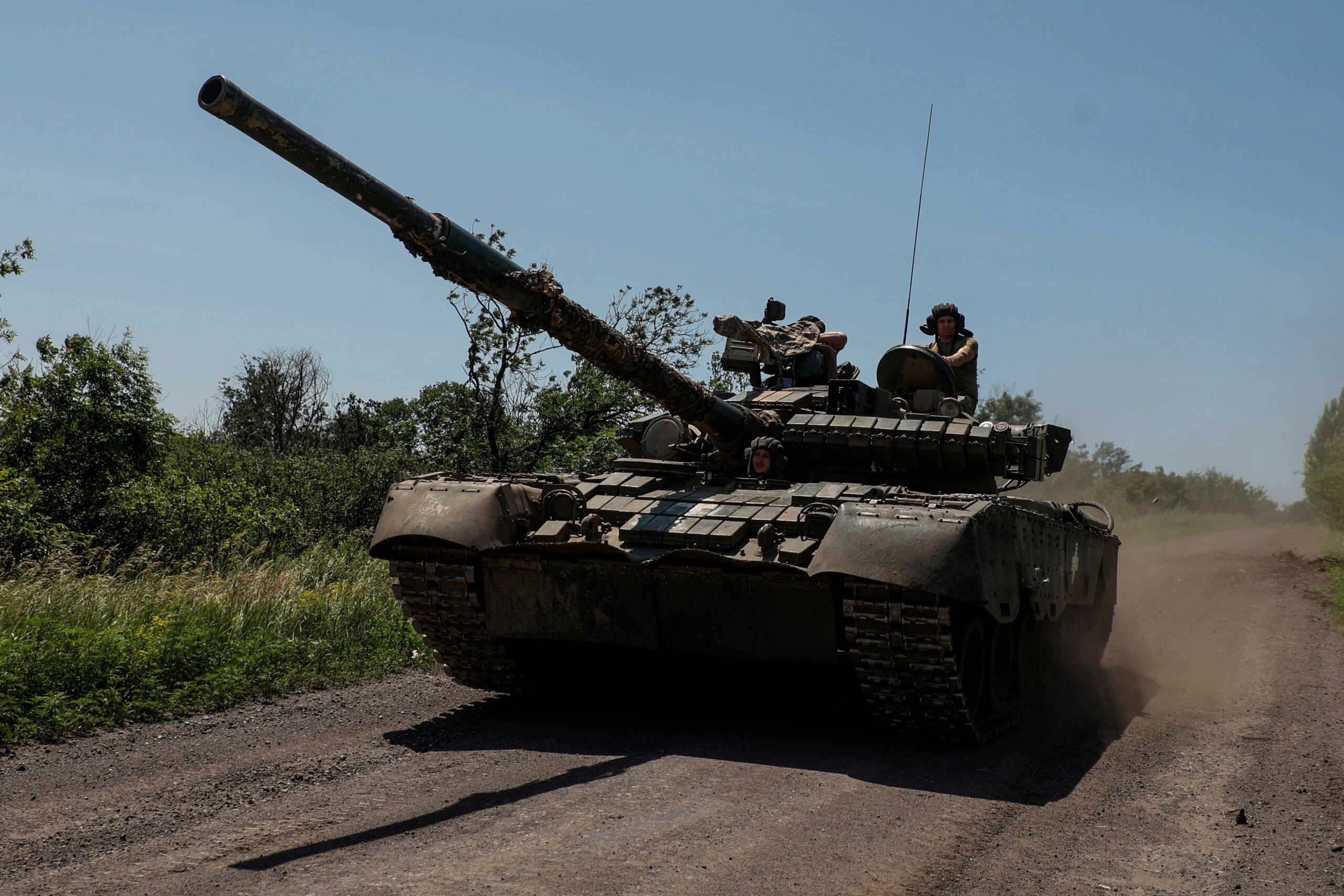 FILE PHOTO: Ukrainian servicemen of the 30th Kostiantyn Ostrozkyi Separate Mechanized Brigade ride in a T-80 main battle tank captured earlier from Russian troops, along a road near the front line town of Bakhmut, amid Russia's attack on Ukraine, in Donetsk region, Ukraine June 19, 2023. Radio Free Europe