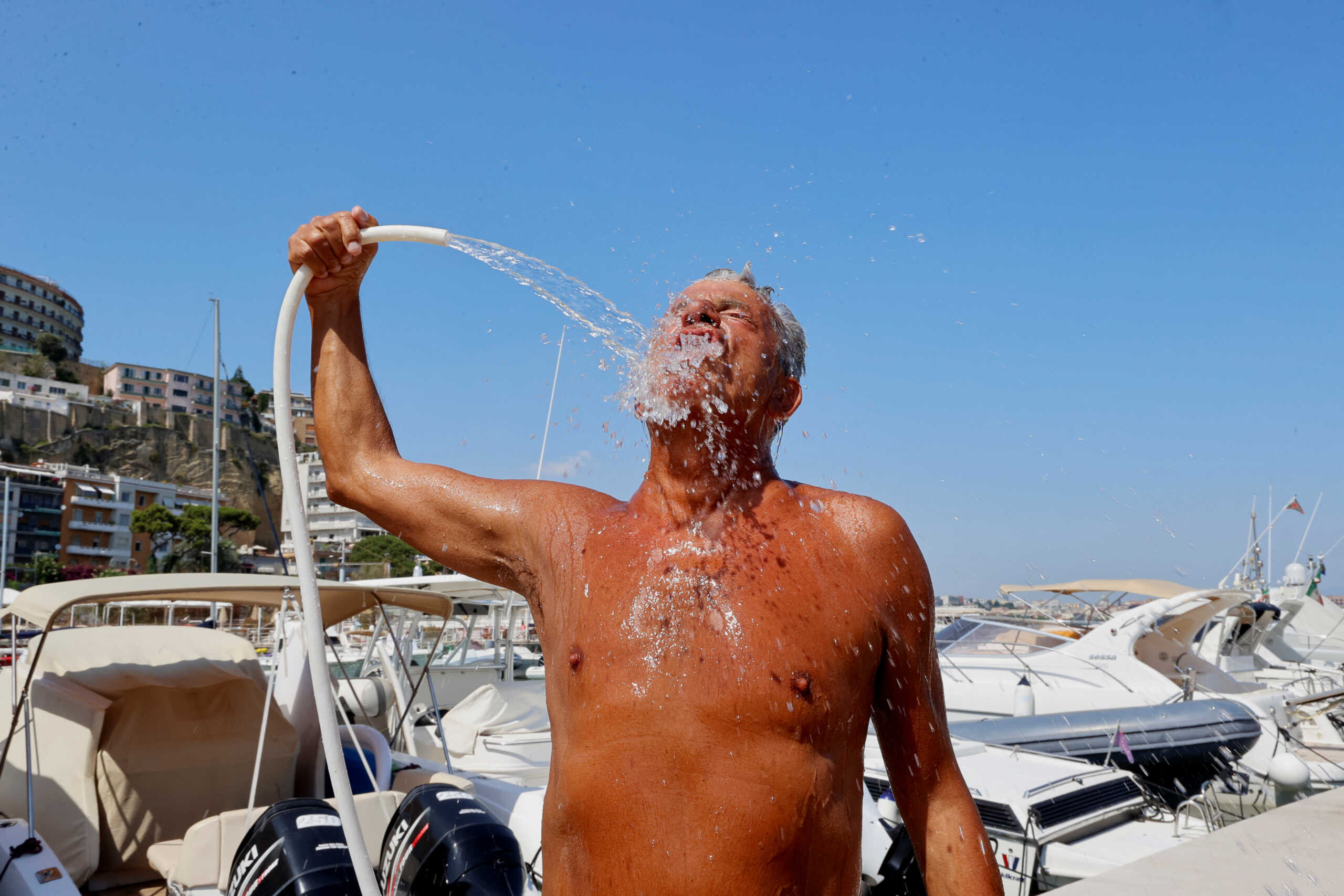 A man cools himself off during a heatwave across Italy, in Naples, Italy July 10, 2023. REUTERS