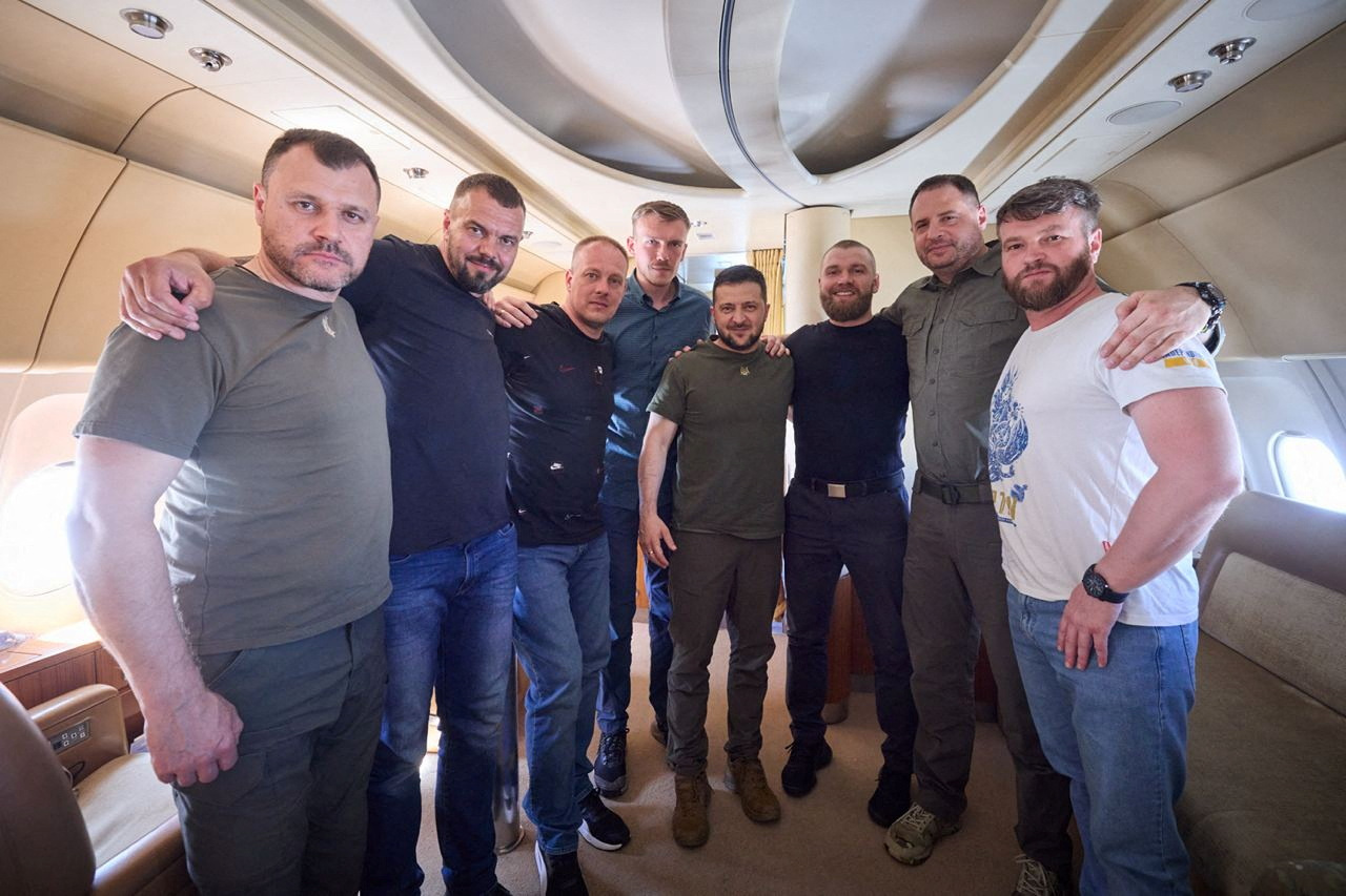 Ukraine's President Volodymyr Zelenskiy, Chief of Staff of Presidential Office Andrew Yermak and Interior Minister Ihor Klymenko pose for a picture with commanders of defenders of the Azovstal Iron and Steel Works in Mariupol Denys Prokopenko, Sviatoslav Palamar, Denys Shleha, Serhii Volynskyi and Oleh Homenko inside a plane as they return to Ukraine from Istanbul, Turkey July 8, 2023. Ukrainian Presidential Press Service