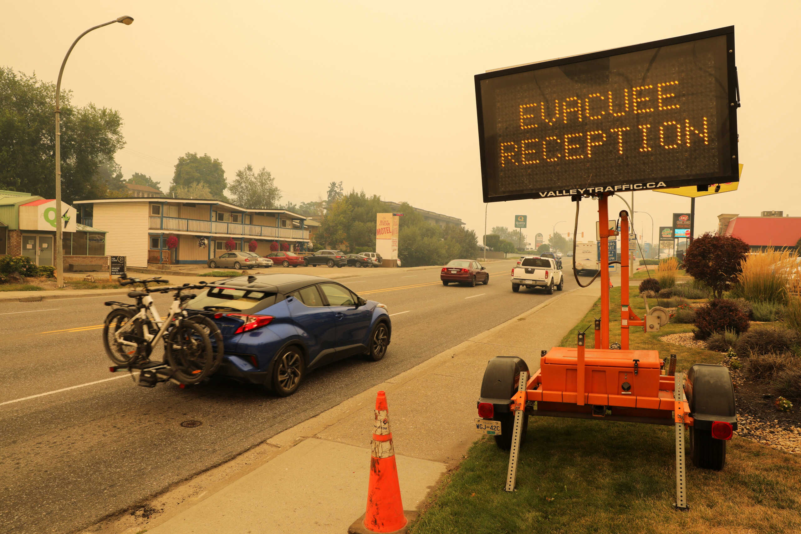 A sign directs motorists to a location for people evacuating from wildfires in Vernon, British Columbia, Canada August 19, 2023. REUTERS
