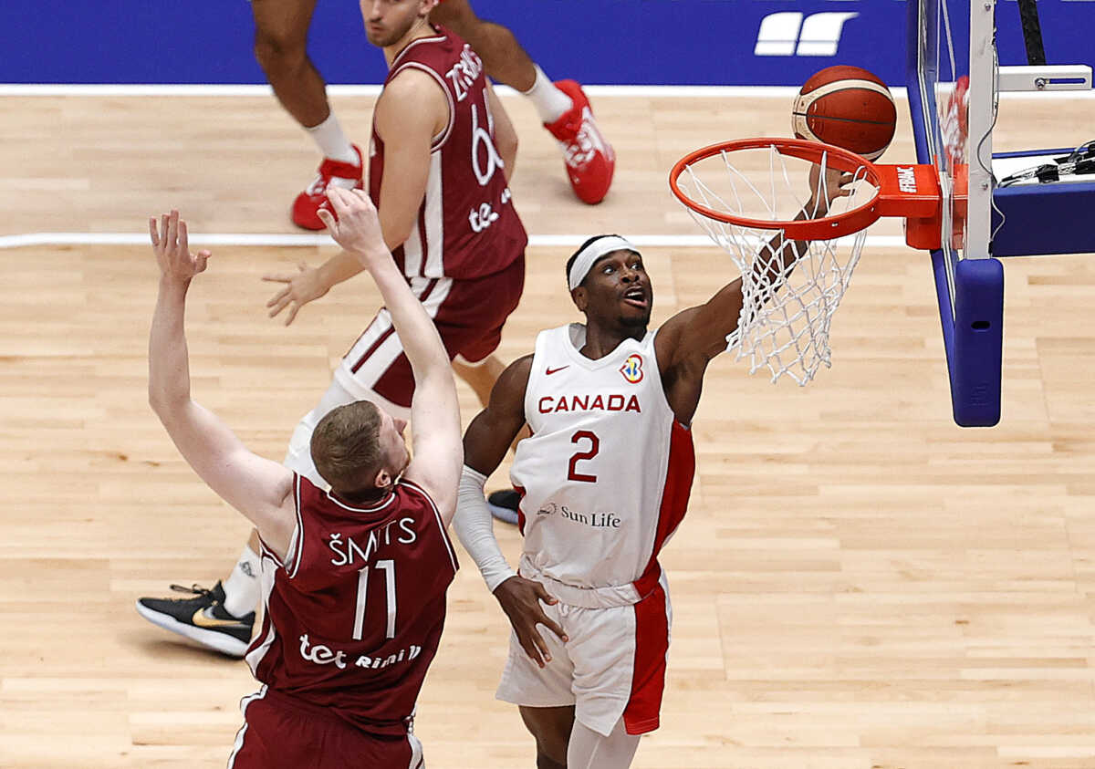 Basketball - FIBA World Cup 2023 - First Round - Group H - Canada v Latvia - Indonesia Arena, Jakarta, Indonesia - August 29, 2023 Canada's Shai Gilgeous-Alexander in action with Latvia's Rolands Smits REUTERS