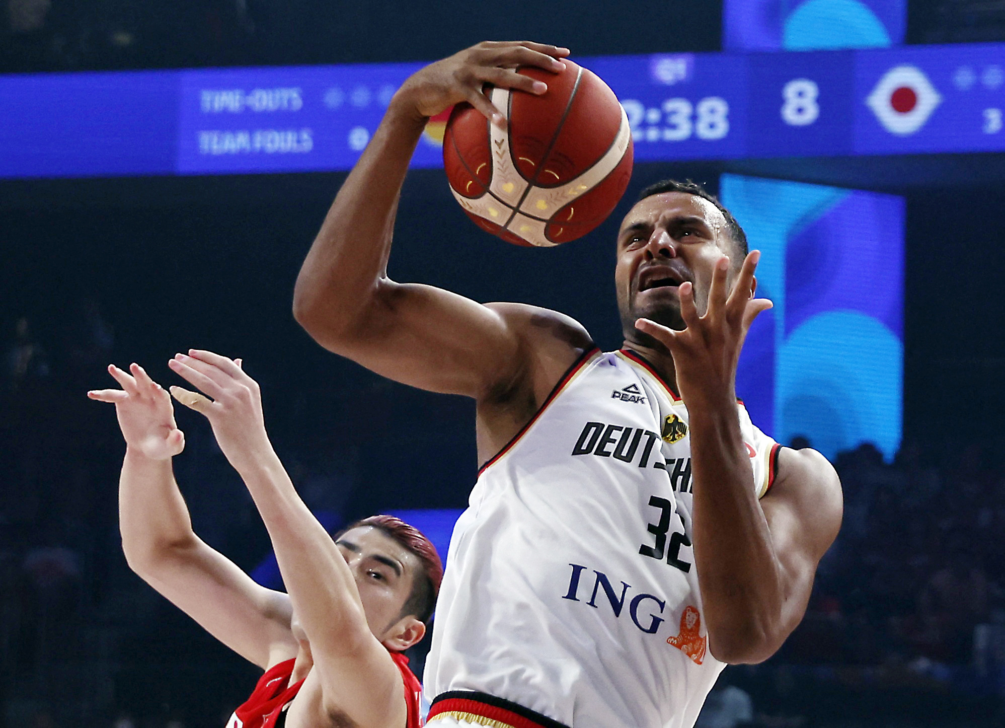 Basketball - FIBA World Cup 2023 - First Round - Group E - Germany v Japan - Okinawa Arena, Okinawa, Japan - August 25, 2023 Germany's Johannes Thiemann in action with Japan's Koya Kawamata REUTERS