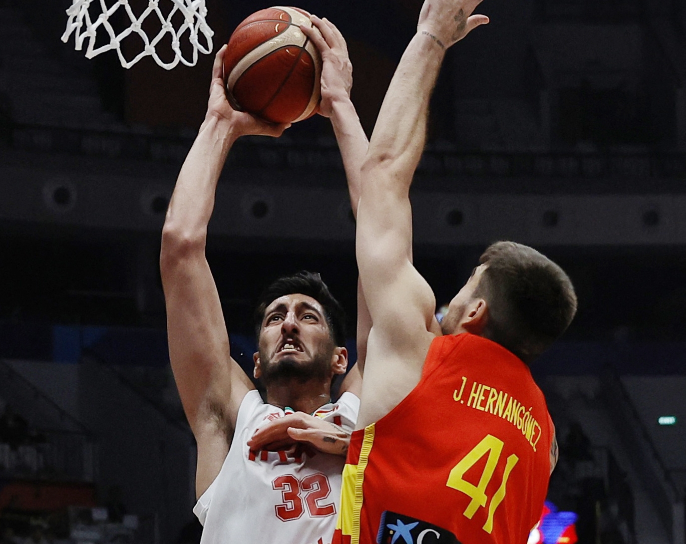 Basketball - FIBA World Cup 2023 - First Round - Group G - Iran v Spain - Indonesia Arena, Jakarta, Indonesia - August 30, 2023 Iran's Hasan Aliakbari and Spain's Juancho Hernangomez in action REUTERS