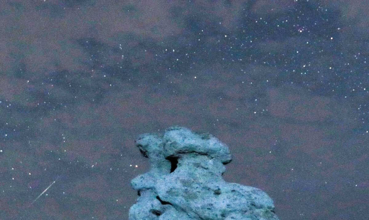 A meteor streaks during the Perseid meteor shower in the night sky over the village of Kuklici, known for its hundreds of naturally formed stones which resemble human beings, near Kratovo, North Macedonia August 13, 2023.REUTERS